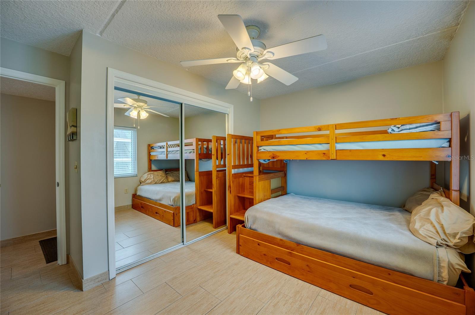 This mirrored closet adds depth and functionality to the space, while the open layout invites personalization. - 6727 TURTLEMOUND RD #315, NEW SMYRNA BEACH