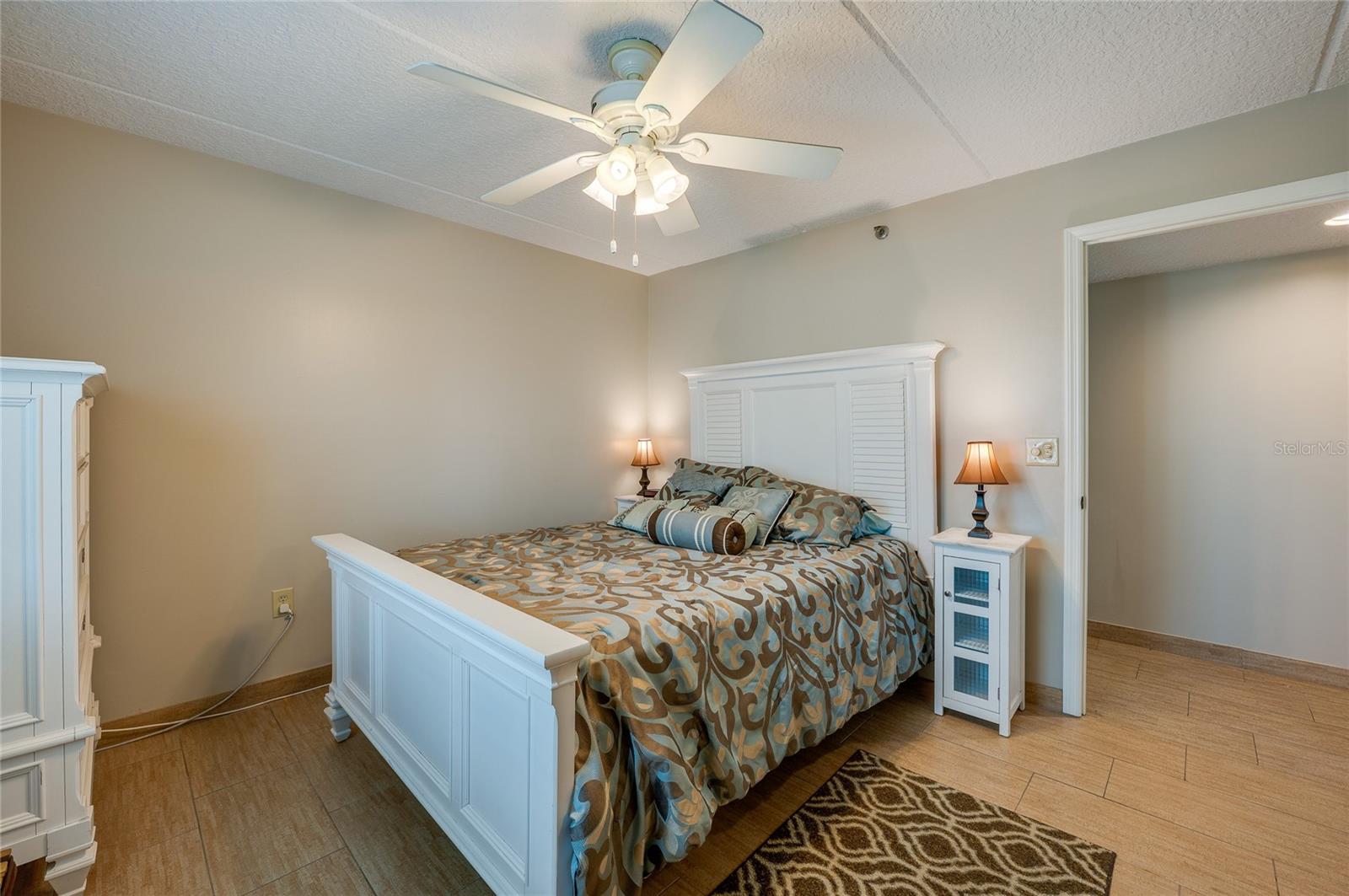 A second angle highlights the room's spacious layout, neutral palette, and direct access to the hallway for added convenience. - 6727 TURTLEMOUND RD #315, NEW SMYRNA BEACH
