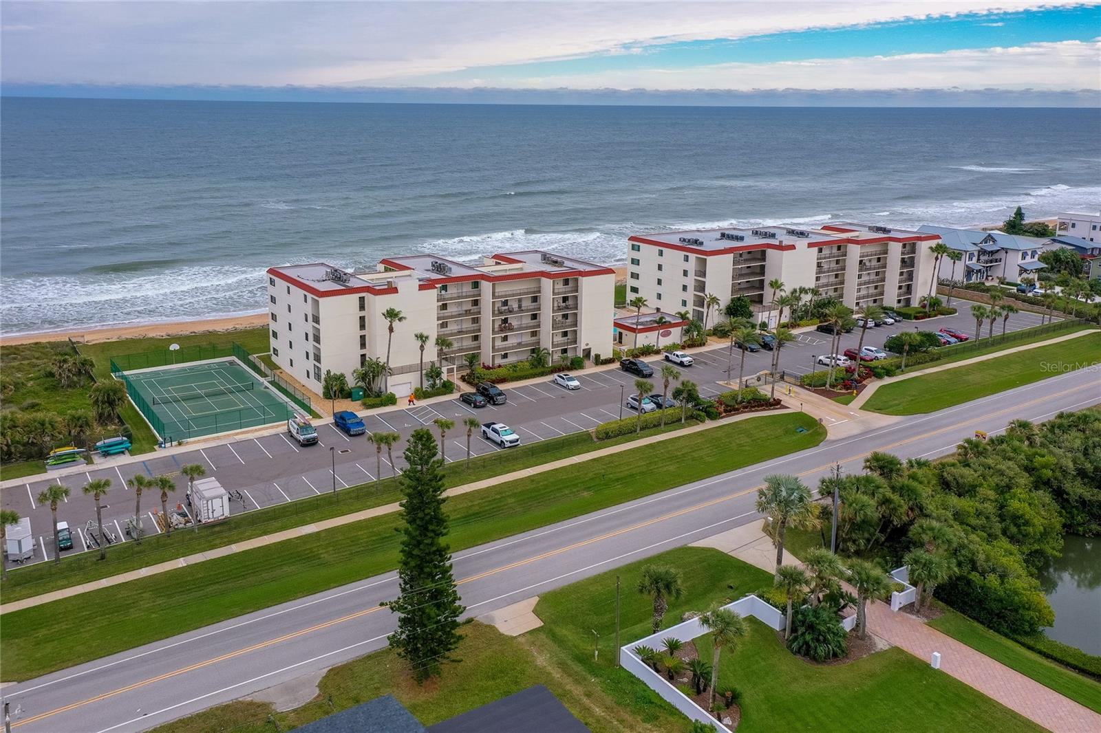 The amenities include a tennis court, ample guest and resident parking, and easy access to the main road—all within a secure and well-kept environment. - 6727 TURTLEMOUND RD #315, NEW SMYRNA BEACH