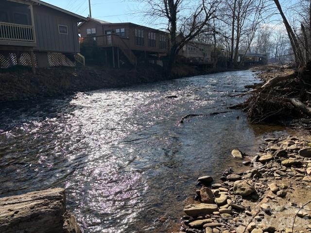 back side of home as seen from across the creek - 129 Mallard Loop, Waynesville