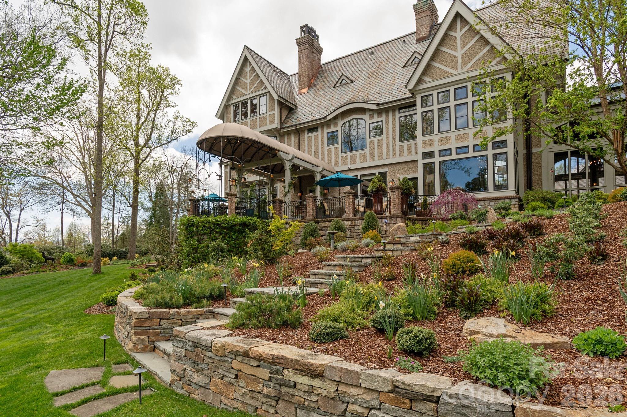 Handcrafted stone retaining walls reflect exceptional masonry - 8 Fairway Place, Asheville