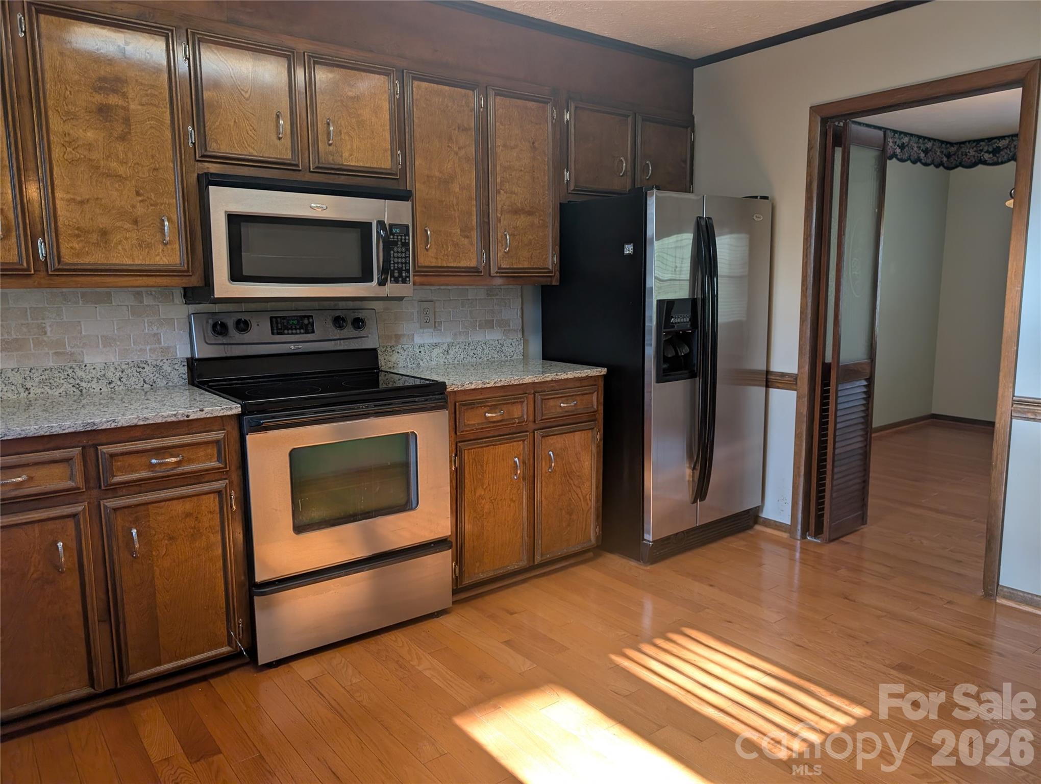 Kitchen with custom cabinets,stainless appliances,with room for a breakfast table - 3065 Woodstream Drive, Valdese