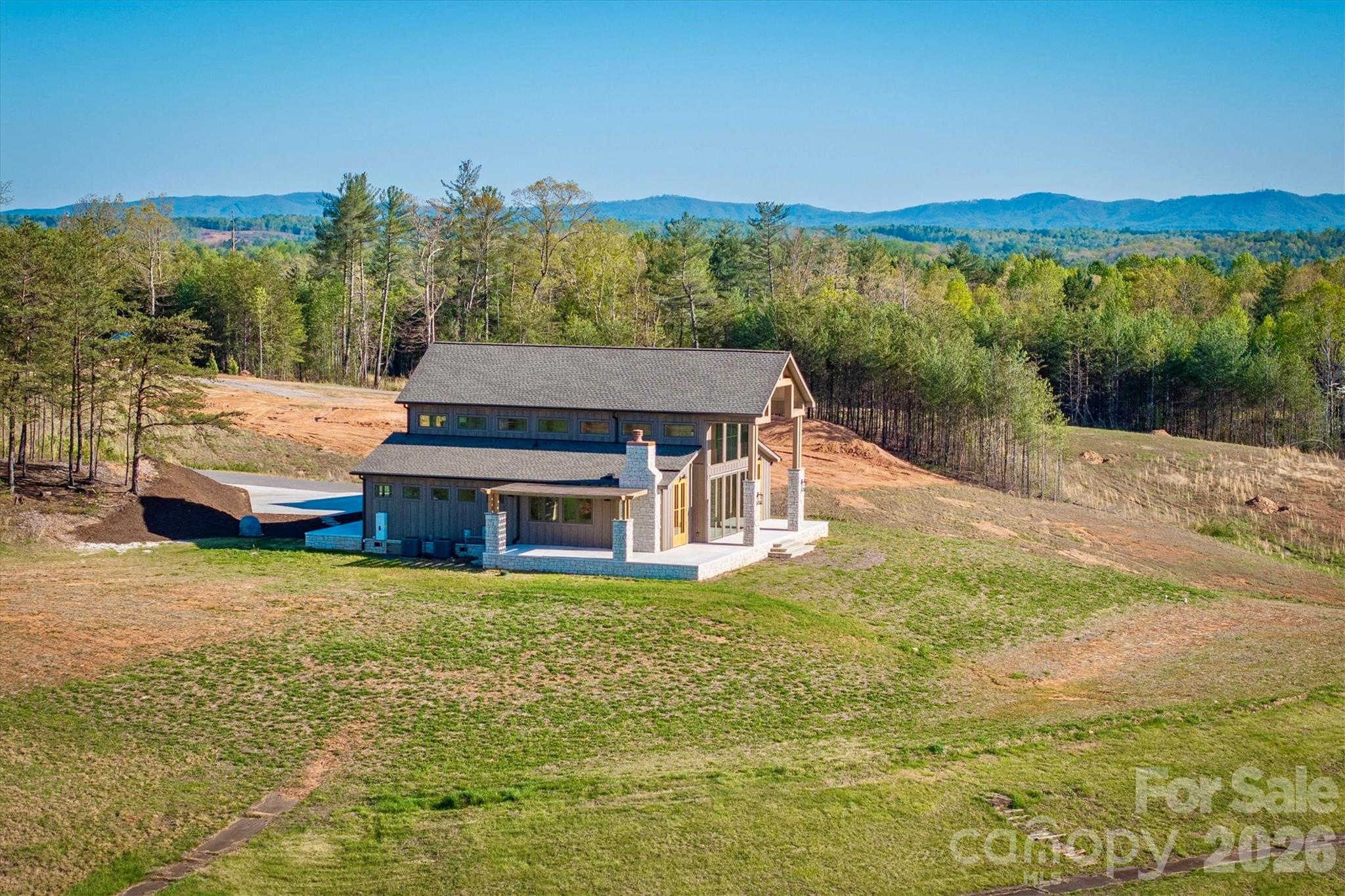 Topography of the lot and surrounding properties affords a gentle, non-steep street and driveway, unusual for a home with such vast long range mountain views. - 2013 Hitching Post Trail, Lenoir