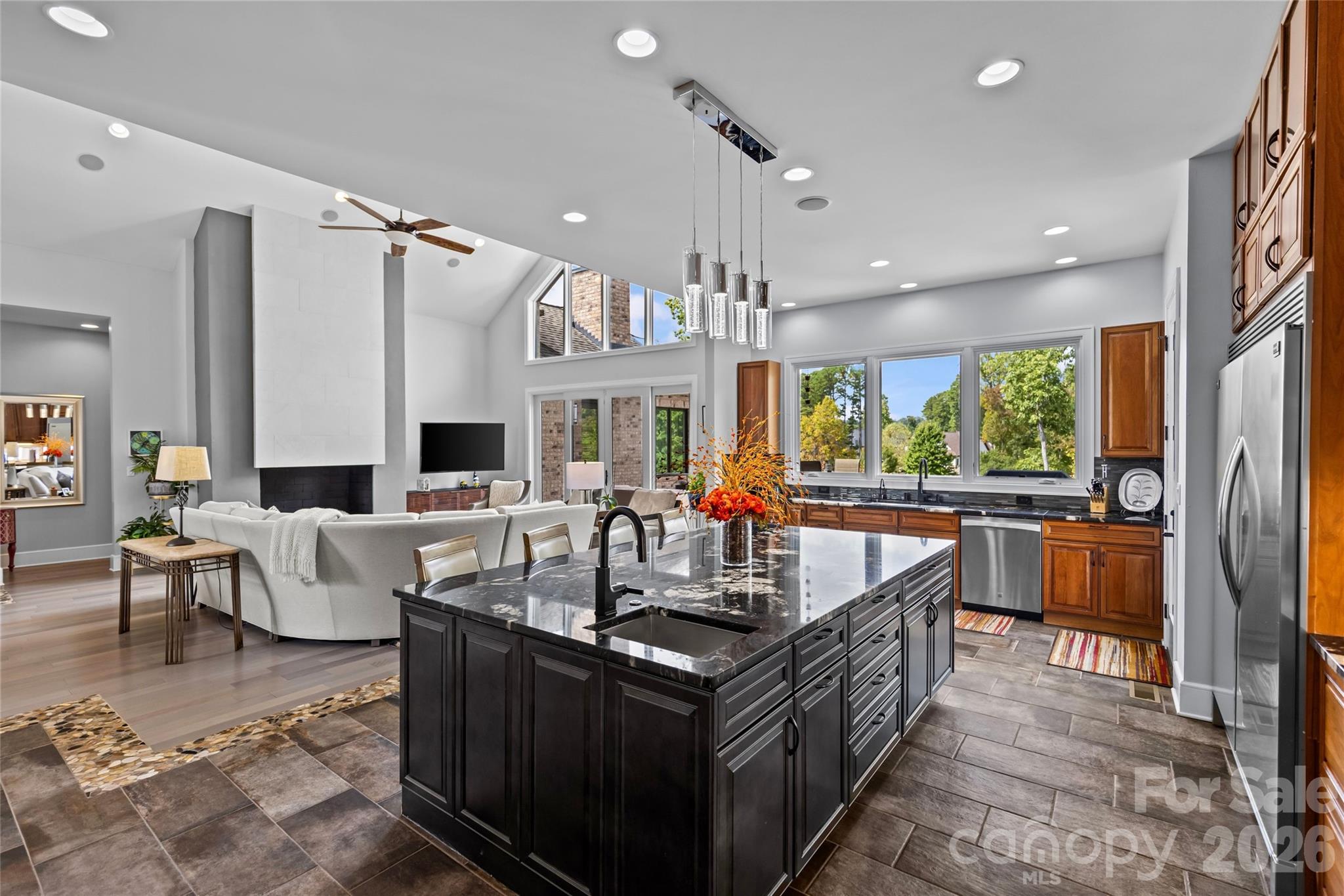 Stunning chef's kitchen has cherry & maple cabinets, granite countertops, oversized kitchen island, dual built-in stainless steel Frigidaire refrigerator & freezer, stainless steel appliances, prep sink in kitchen island with disposal, large butlers pantry with additional sink & dishwasher, & bar with ice maker. - 6032 Headlands Court, Belmont