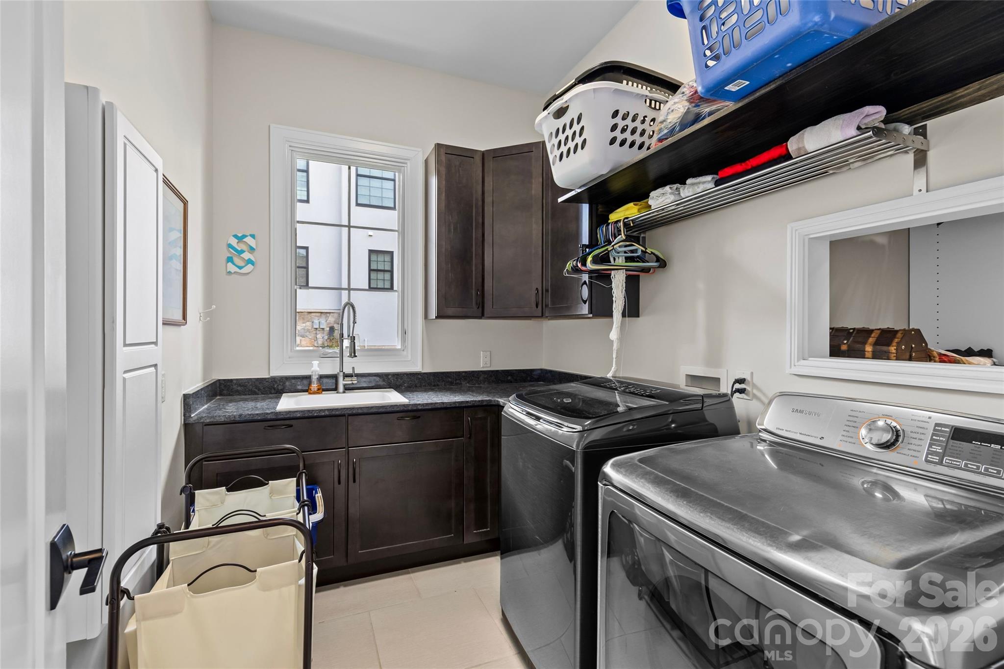 Primary suite has stunning lake views, gas fireplace, sitting area/office, double vanity, shower, bathtub, water closet & walk-in closet with access to the laundry room. - 6032 Headlands Court, Belmont