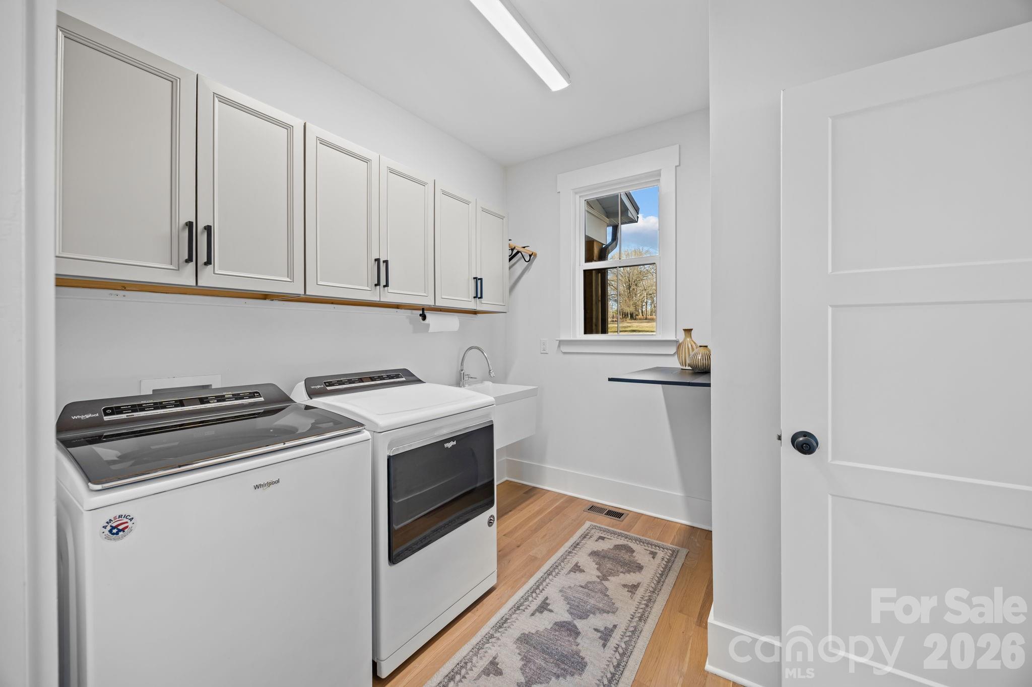 Spacious laundry room- sink, storage- located right outside Primary on main level - 5020 Slanting Bridge Road, Sherrills Ford