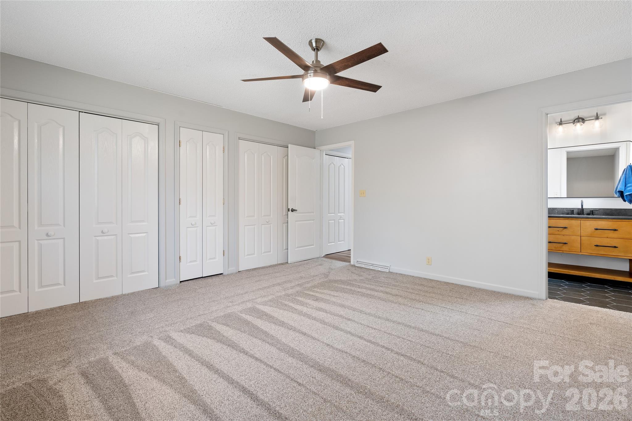 Primary bedroom into primary bathroom - 177 Country Road, Brevard