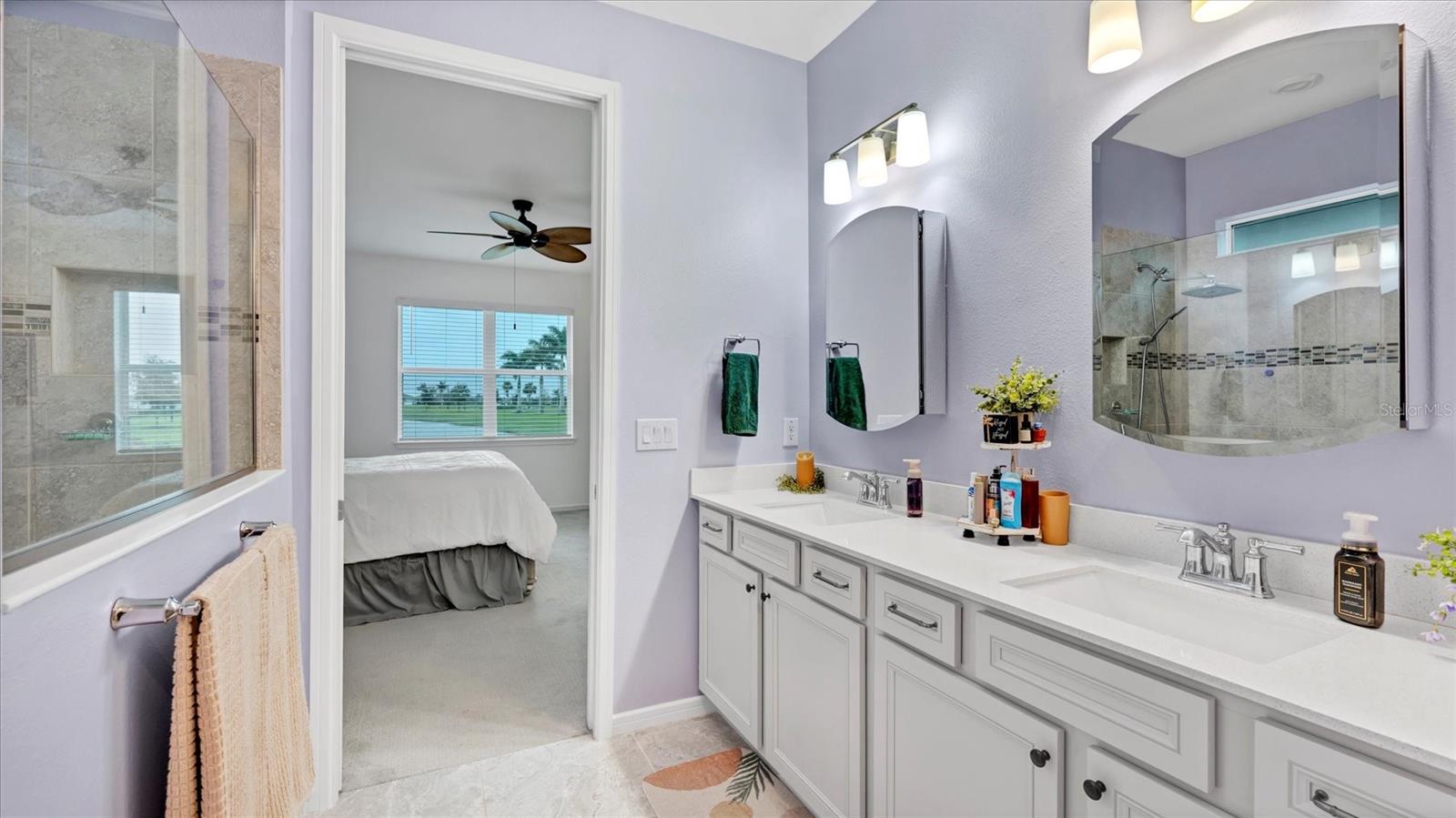 Primary bathroom with medicine cabinet mirrors and dual vanity sinks - 8705 COASTAL KEY WAY, PARRISH