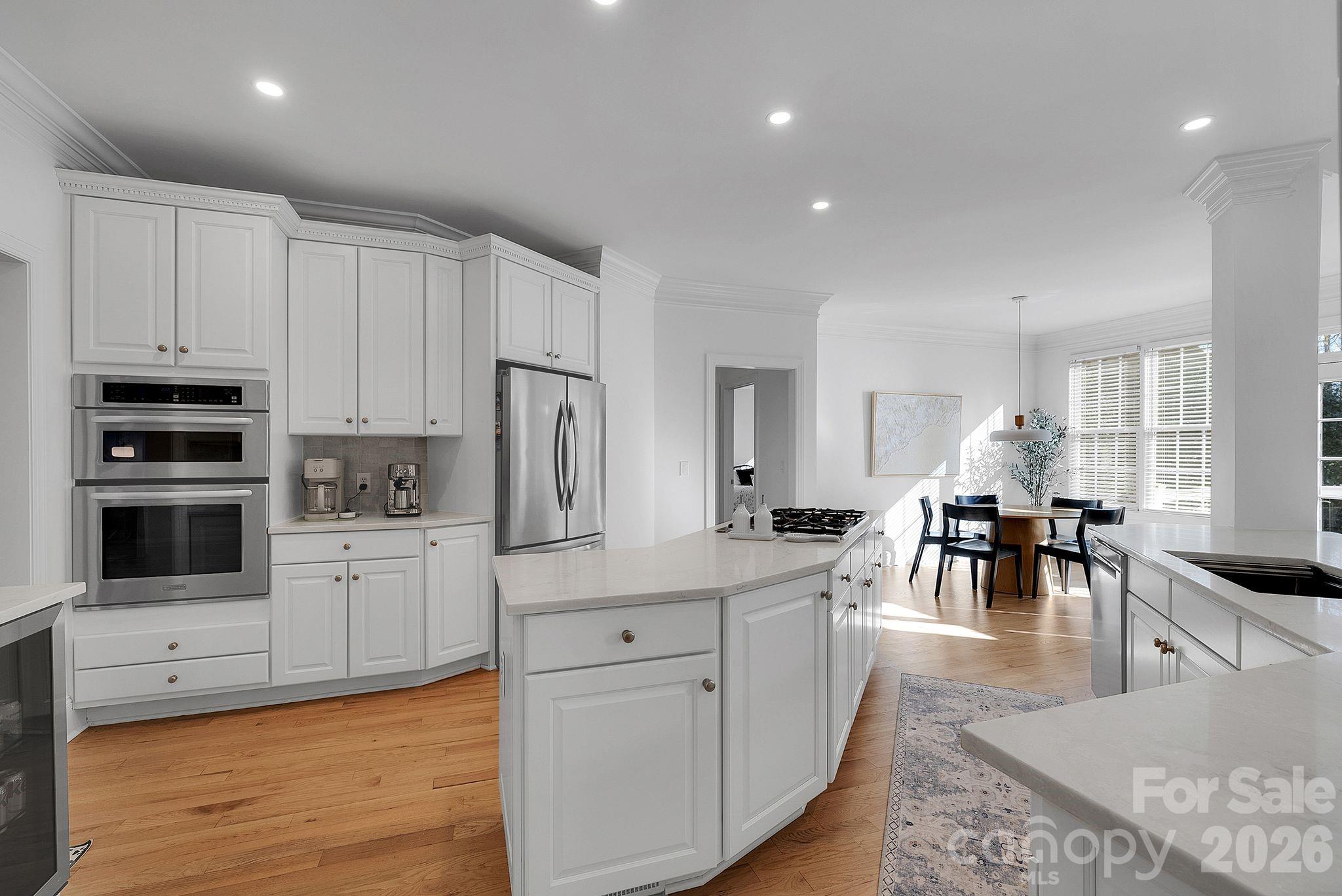 Additional kitchen view highlighting stainless steel appliances, ample counter space, and abundant cabinetry. The layout supports both everyday use and entertaining. - 7778 Burning Ridge Drive, Stanley