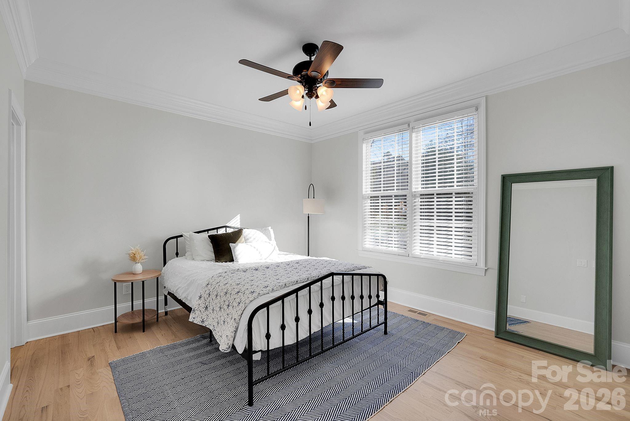 Well-sized secondary bedroom featuring neutral finishes, ceiling fan, and natural light. Flexible space suitable for a variety of uses - 7778 Burning Ridge Drive, Stanley