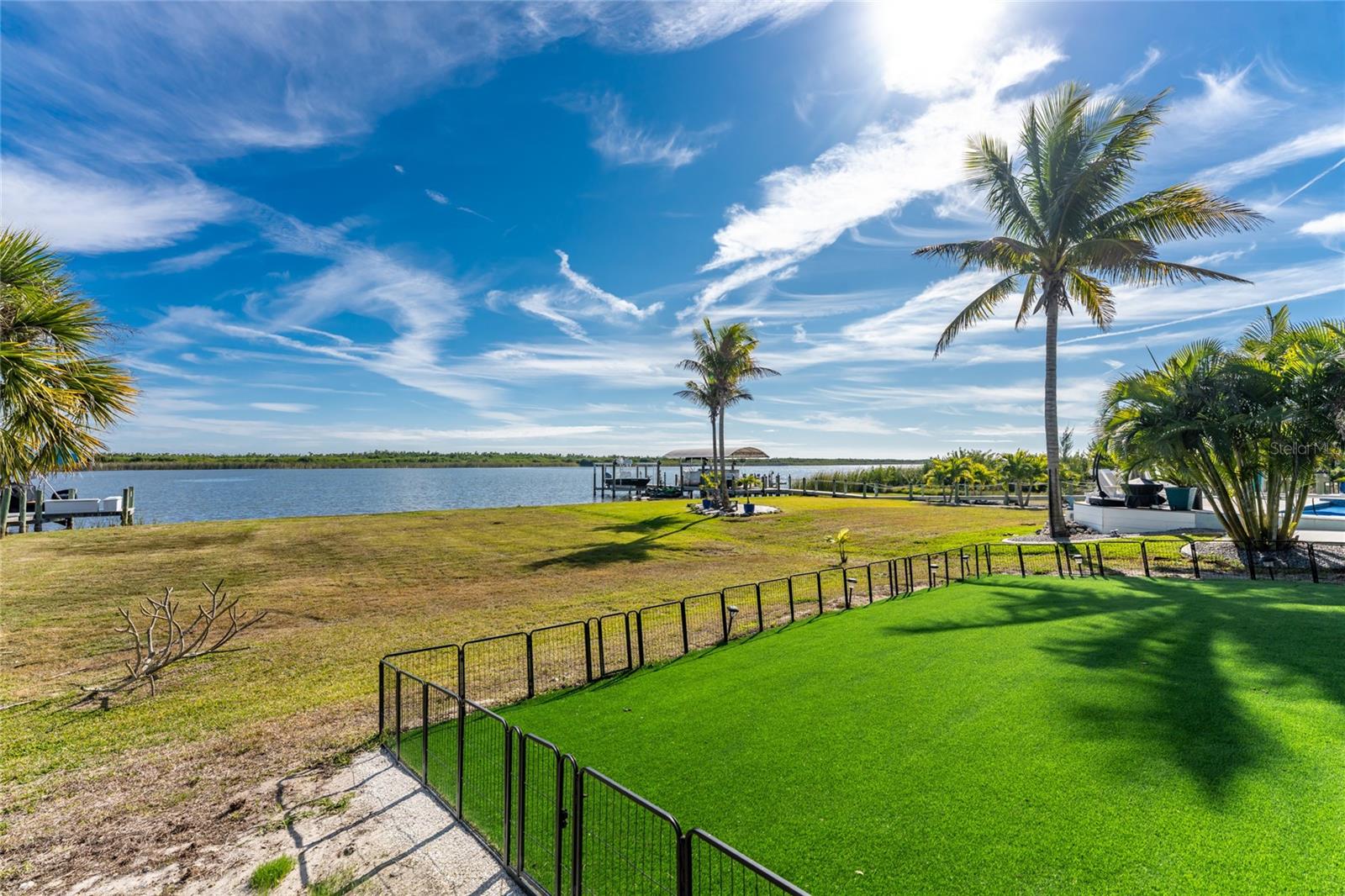 Fenced in dog run with pet friendly artificial turf. - 16168 LA BARGE CIR, PORT CHARLOTTE