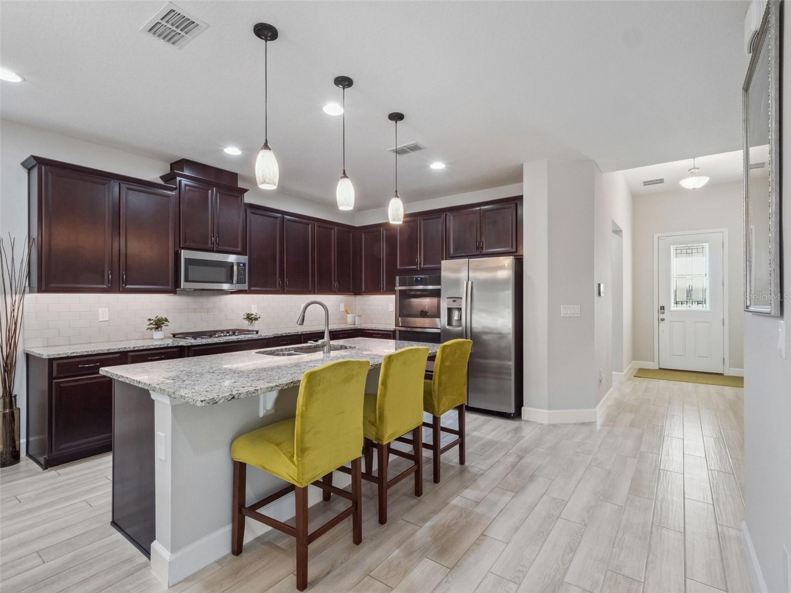Kitchen towards foyer + bedroom 1 - 14345 WABASSO LOOP, WINTER GARDEN