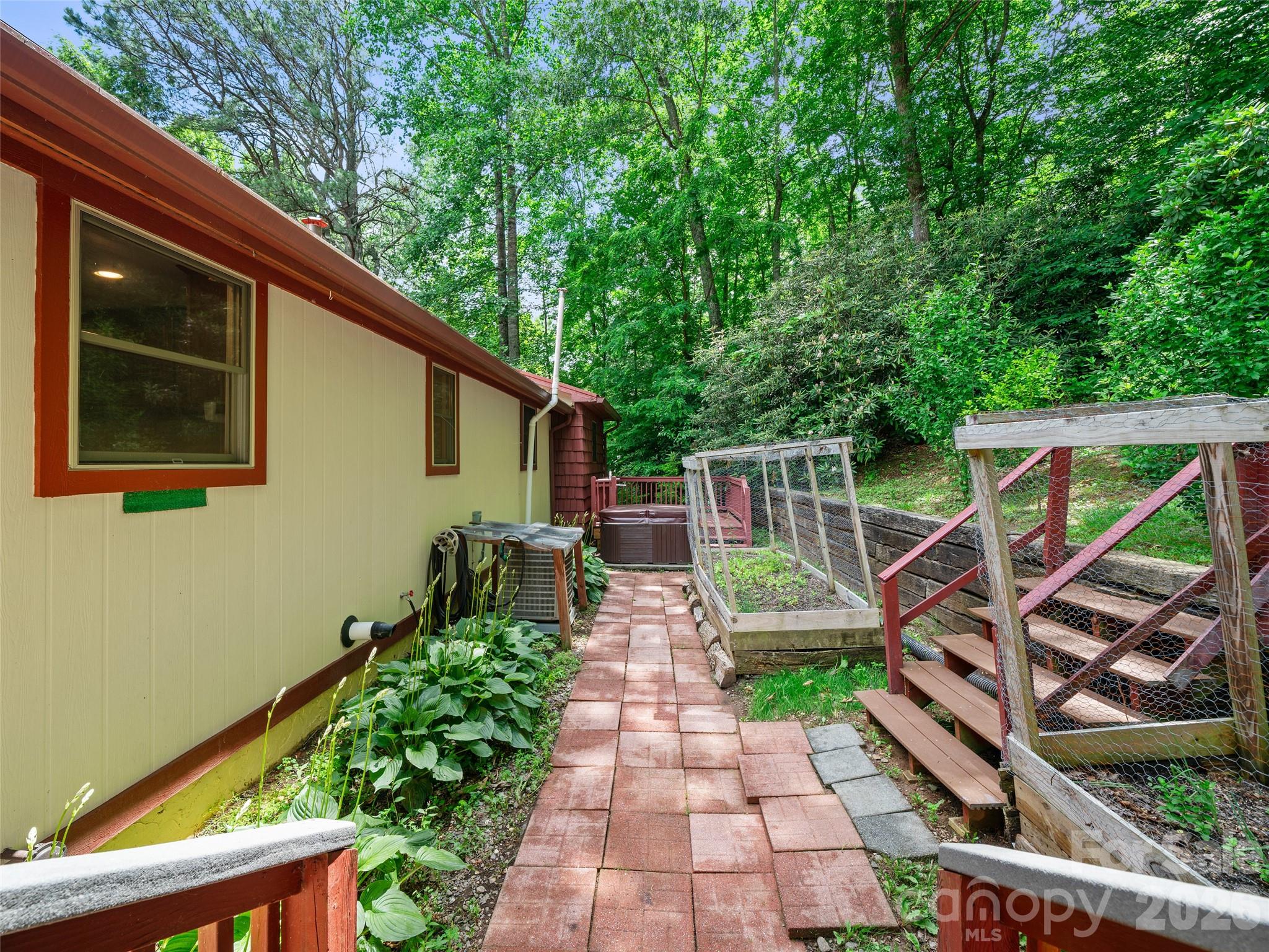 Behind house, Hot Tub, Garden beds, Landscape - 125 HEARTLAND Lane, Burnsville