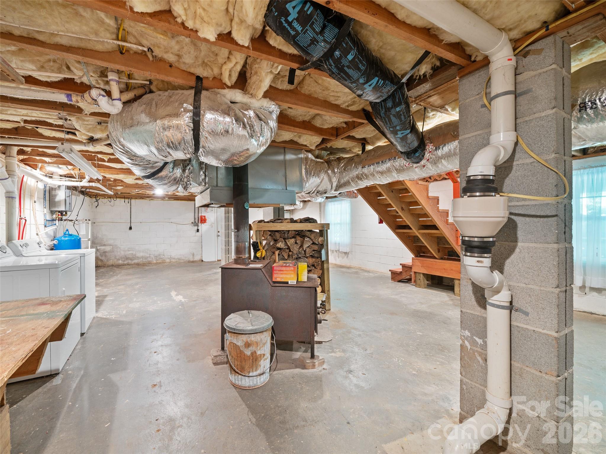 Unfinished basement with wood stove. - 125 HEARTLAND Lane, Burnsville