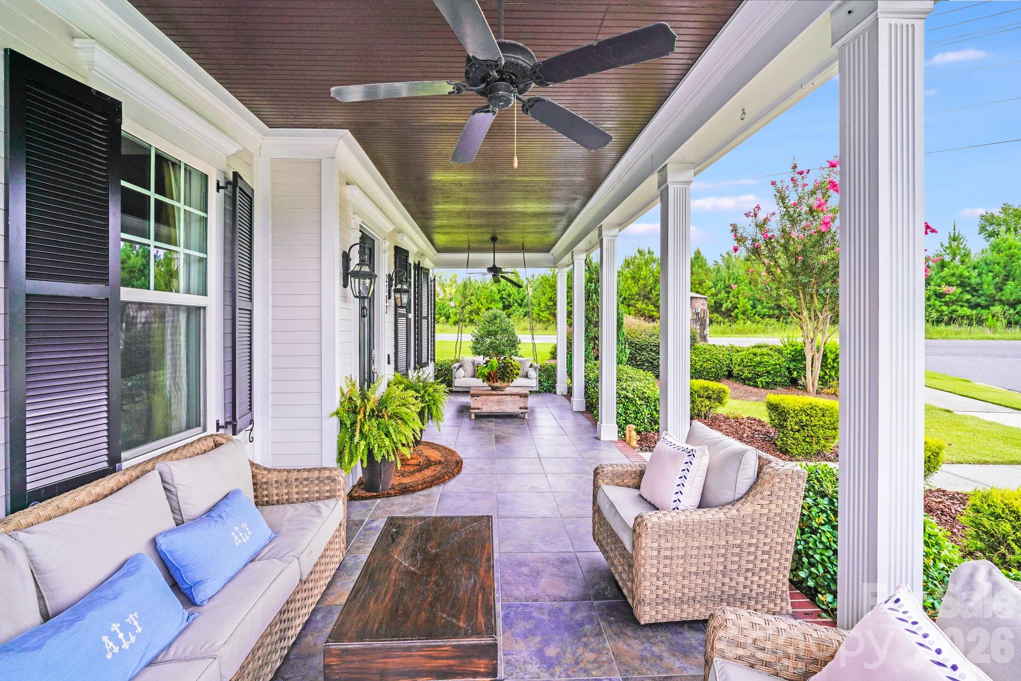 Stylish black shutters and lantern-style lighting accentuate the crisp white siding and black front door - 2702 Arsdale Road, Waxhaw