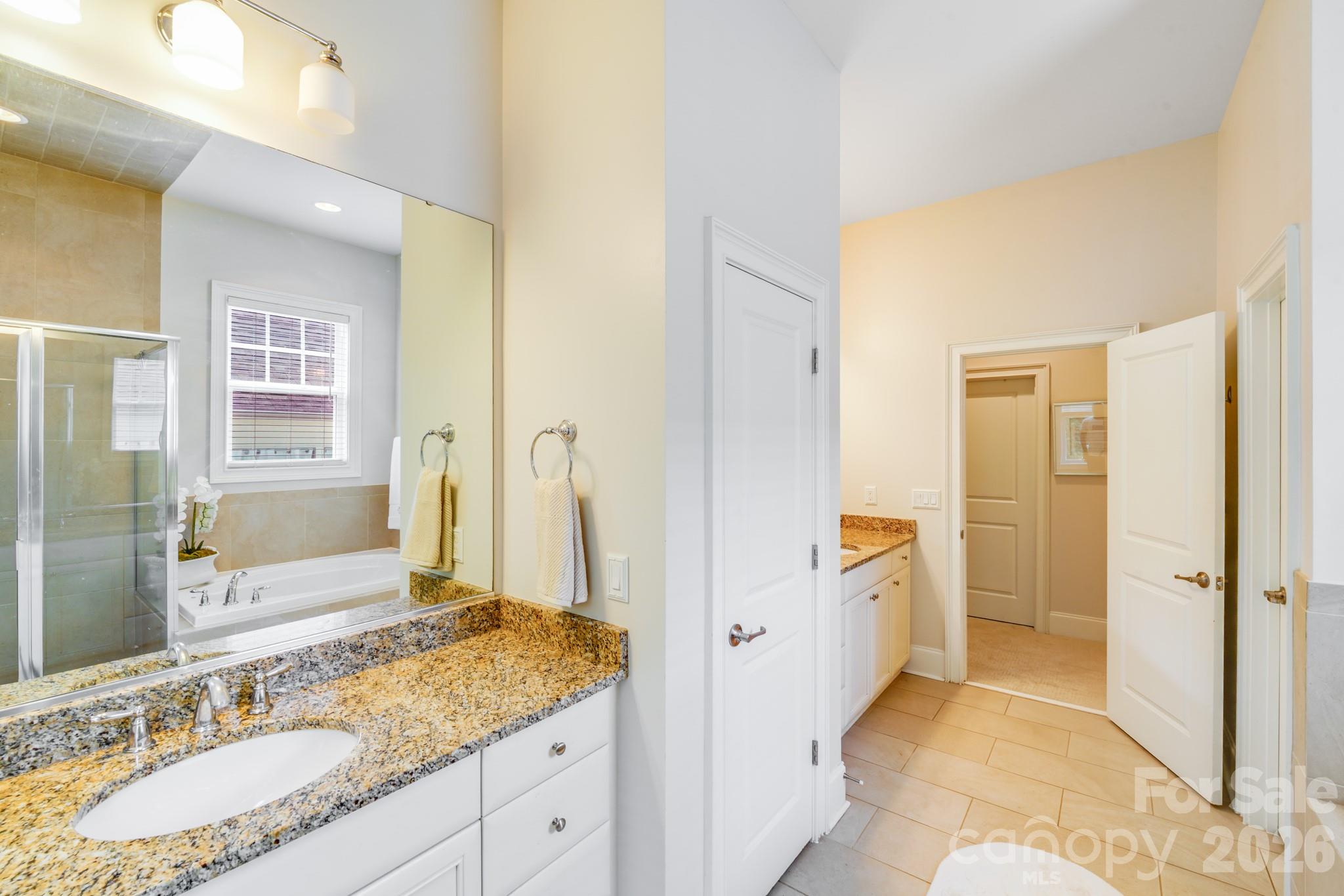 This final view of the primary en-suite bath emphasizes its functionality and spacious dual-vanity layout. - 2702 Arsdale Road, Waxhaw