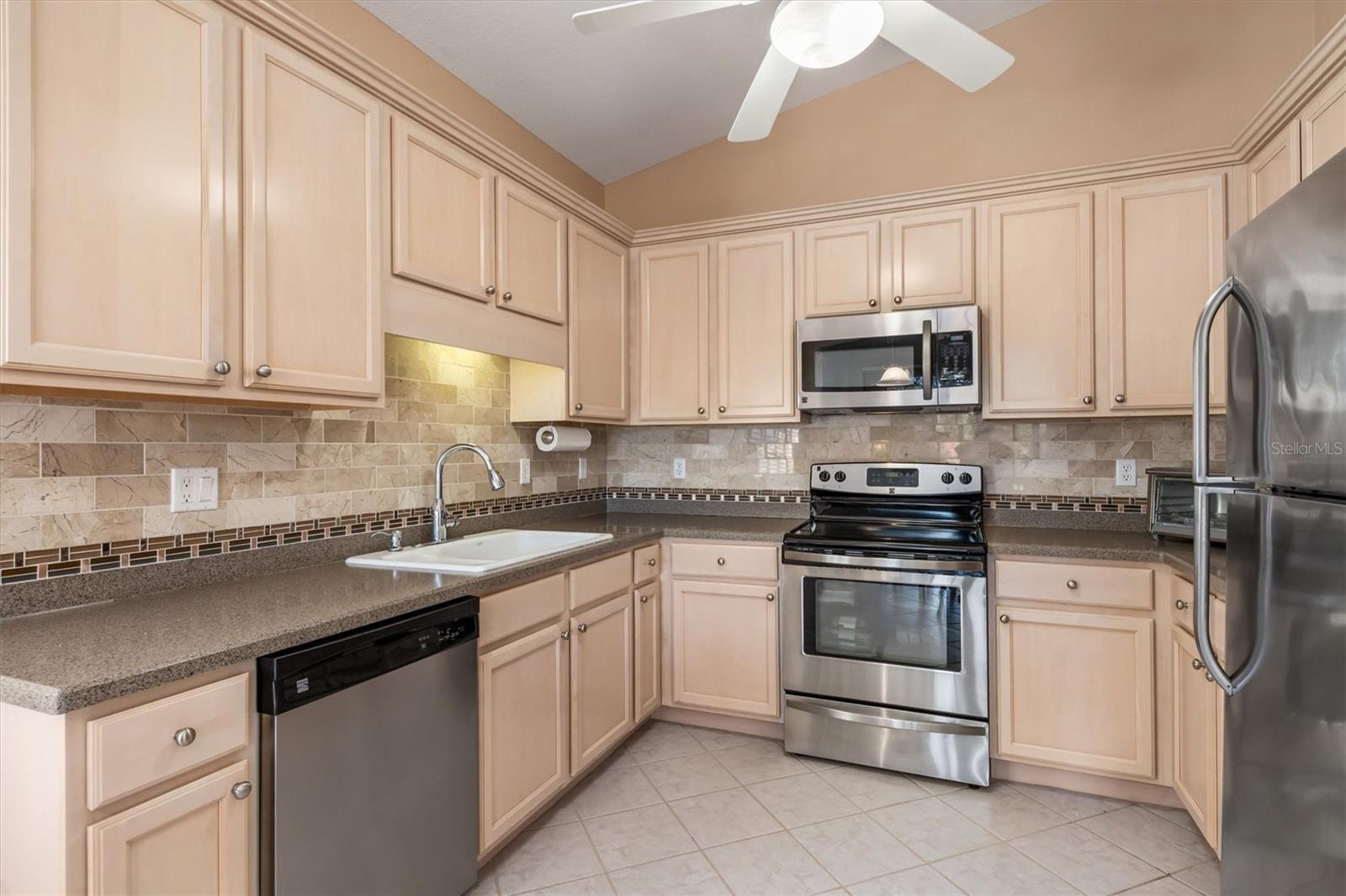 Plenty of wood cabinetry, and an eat-in kitchen! - 3322 GRAND VISTA CT #203, PORT CHARLOTTE