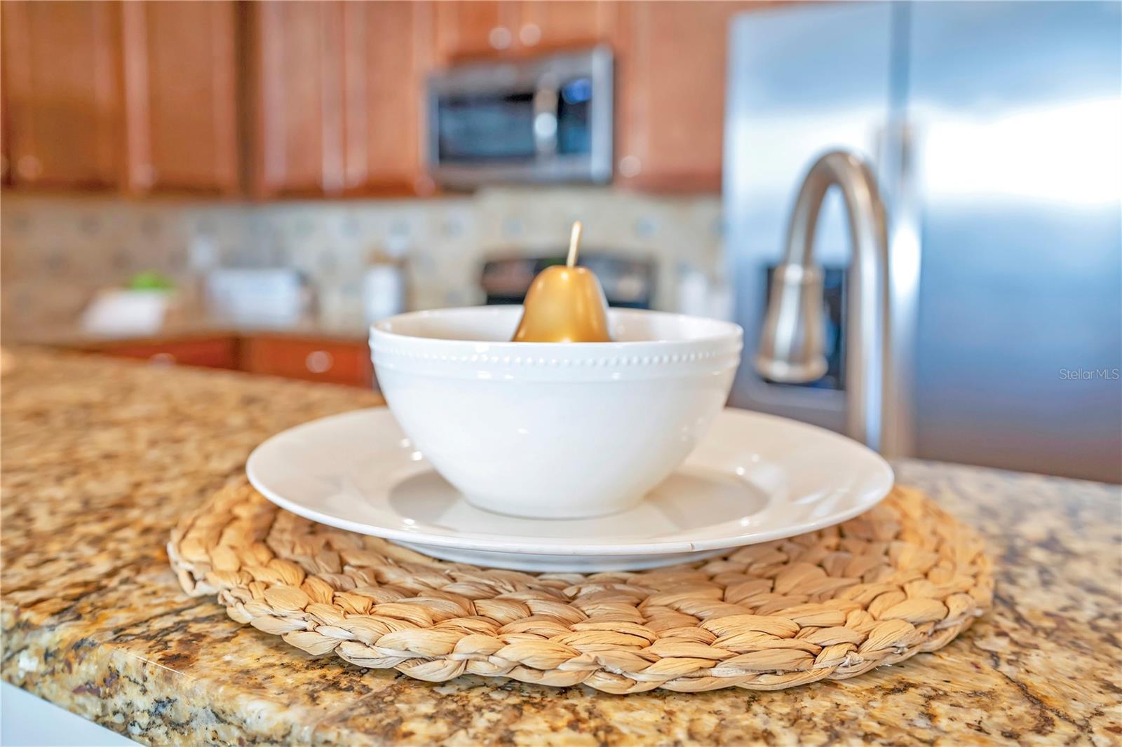 Granite countertops and stainless appliances create a polished, upscale cooking space. - 631 LASSO DR, KISSIMMEE