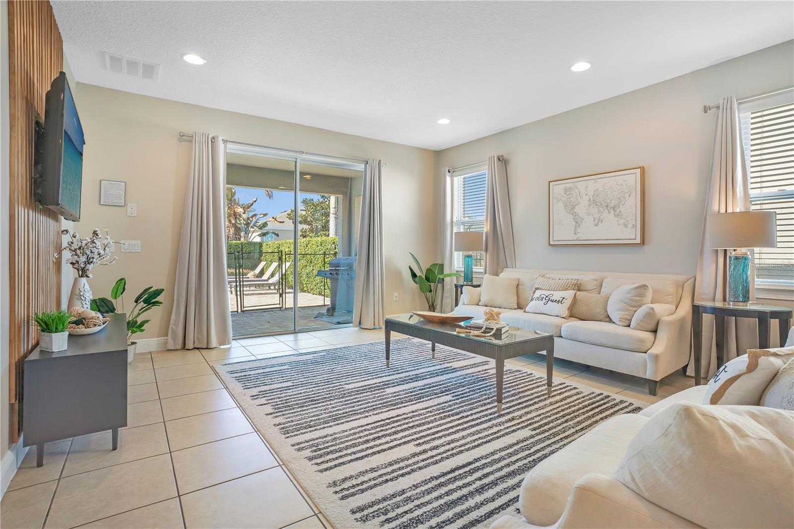 Comfortable gathering space with easy access to outdoor living areas - 631 LASSO DR, KISSIMMEE