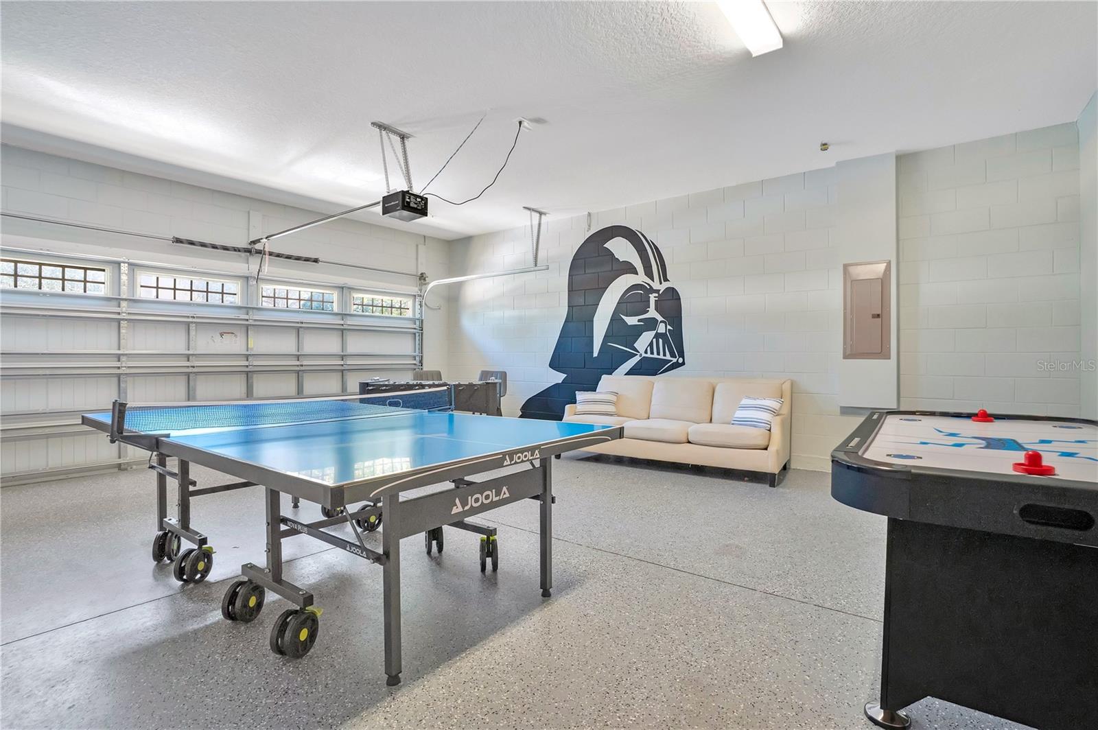 Immersive recreation space featuring ping pong and interactive gaming zones - 631 LASSO DR, KISSIMMEE