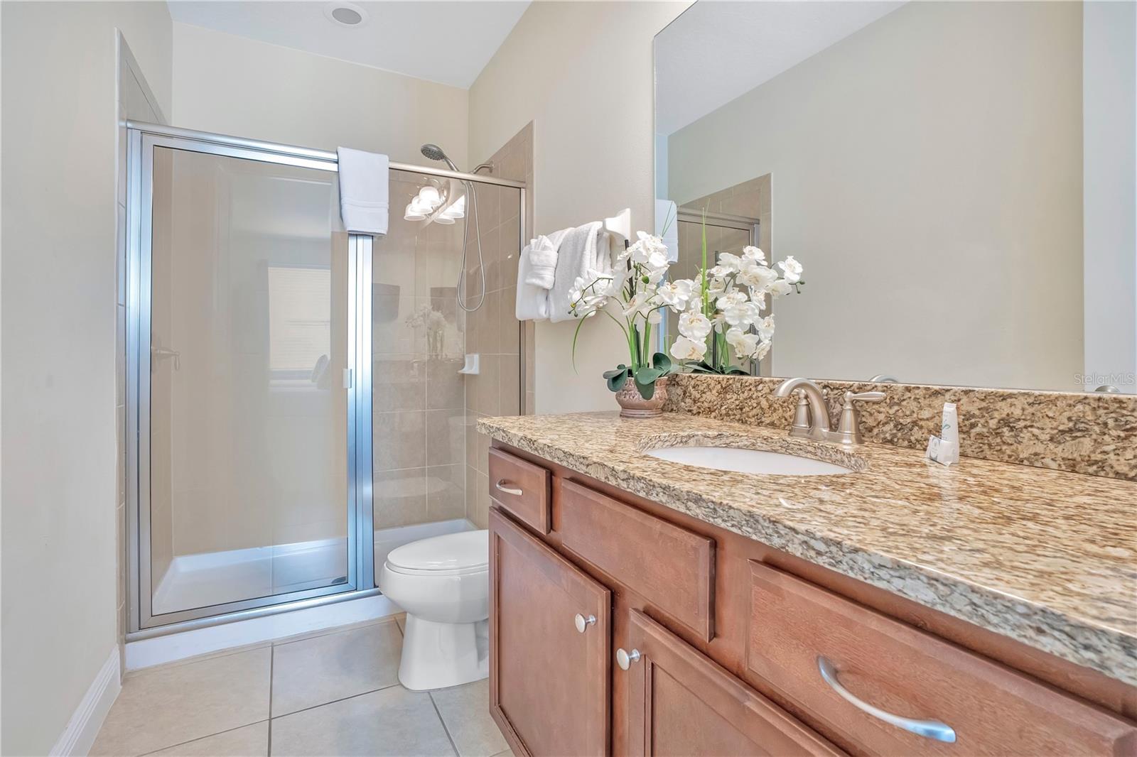 Ensuite to the 'Rivera Maya' Suite - with granite vanity and modern finishes serving this themed suite - 631 LASSO DR, KISSIMMEE