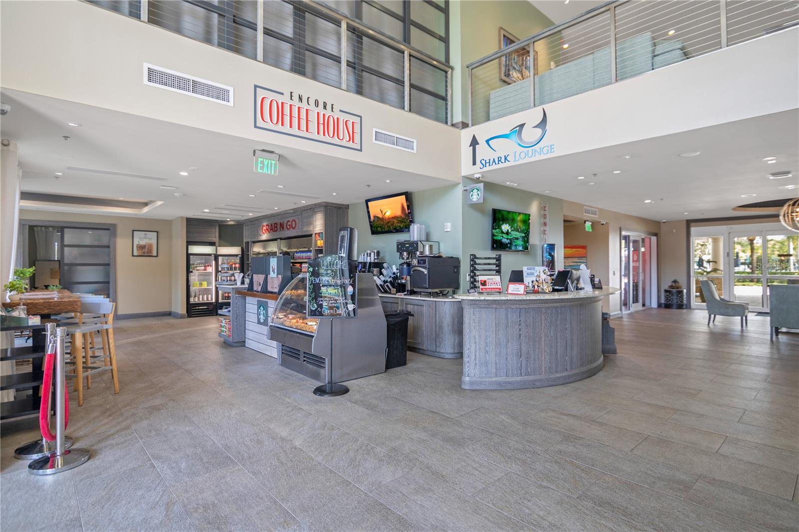 Encore Resort clubhouse interior with concierge services, dining, and guest amenities - 631 LASSO DR, KISSIMMEE