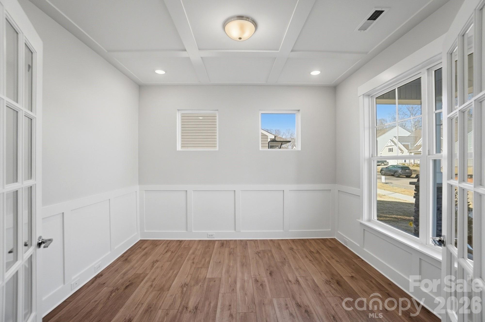 Office with faux coffered ceiling, French doors, and wainscoting - 5054 McLaughlin Loop, Waxhaw