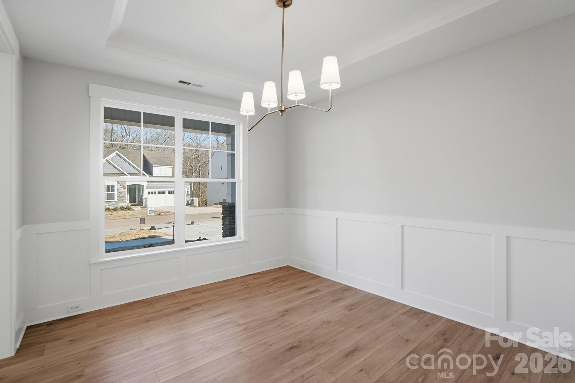 Dining room with Craftsman-style trim and tray ceiling - 5054 McLaughlin Loop, Waxhaw