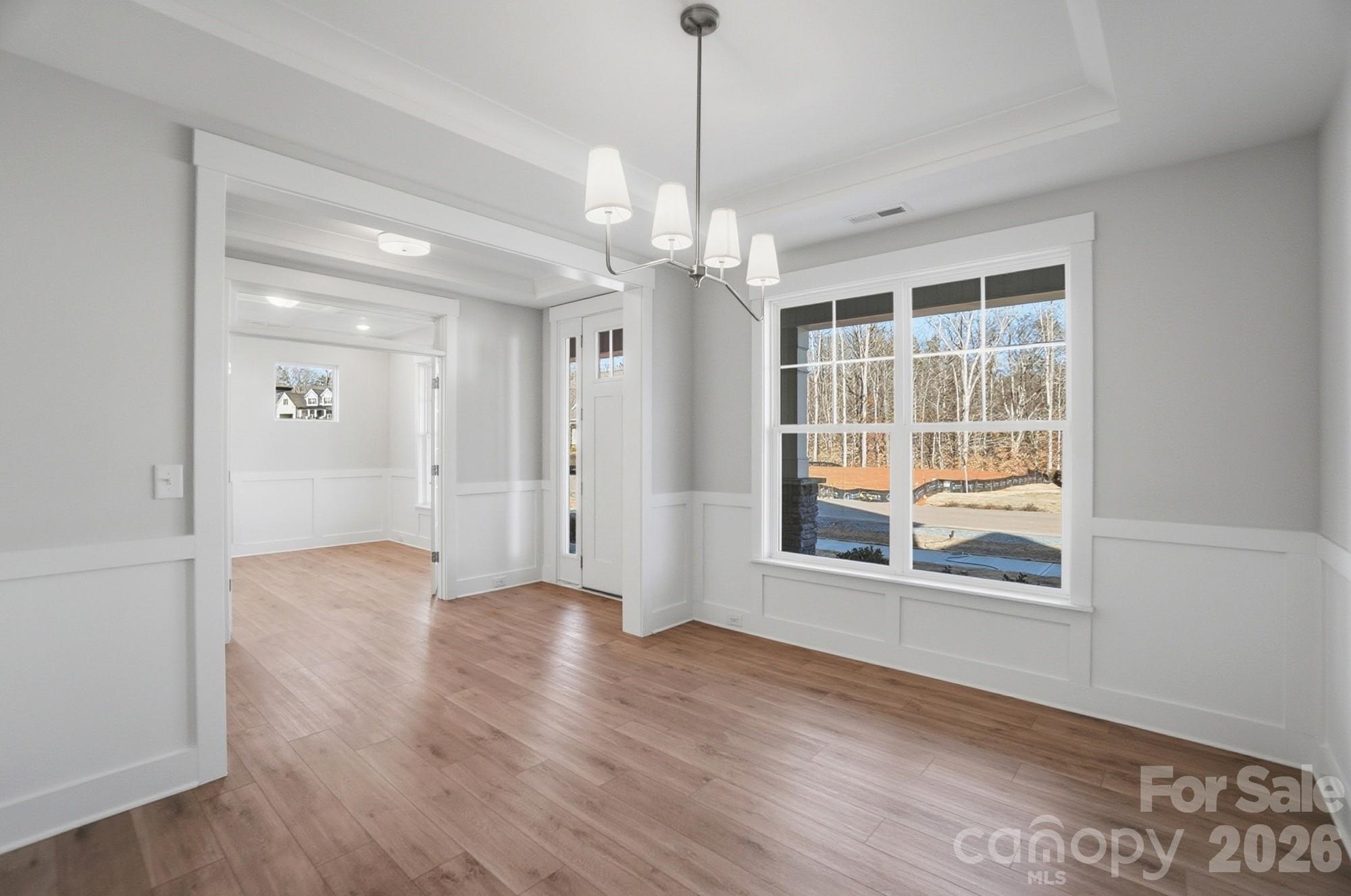 Dining room with Craftsman-style trim and tray ceiling - 5054 McLaughlin Loop, Waxhaw