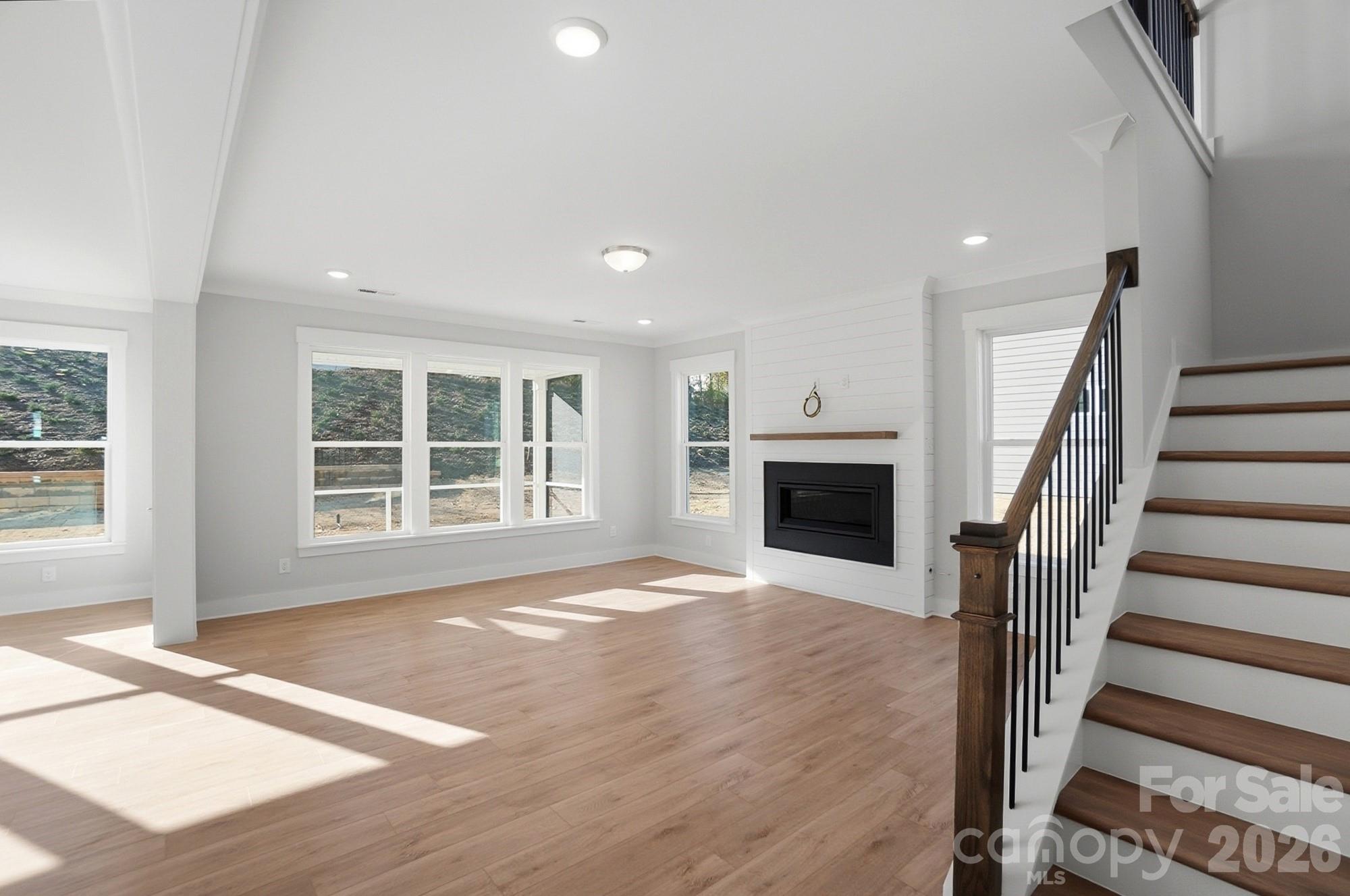Family room with Cosmo fireplace and shiplap feature wall - 5054 McLaughlin Loop, Waxhaw