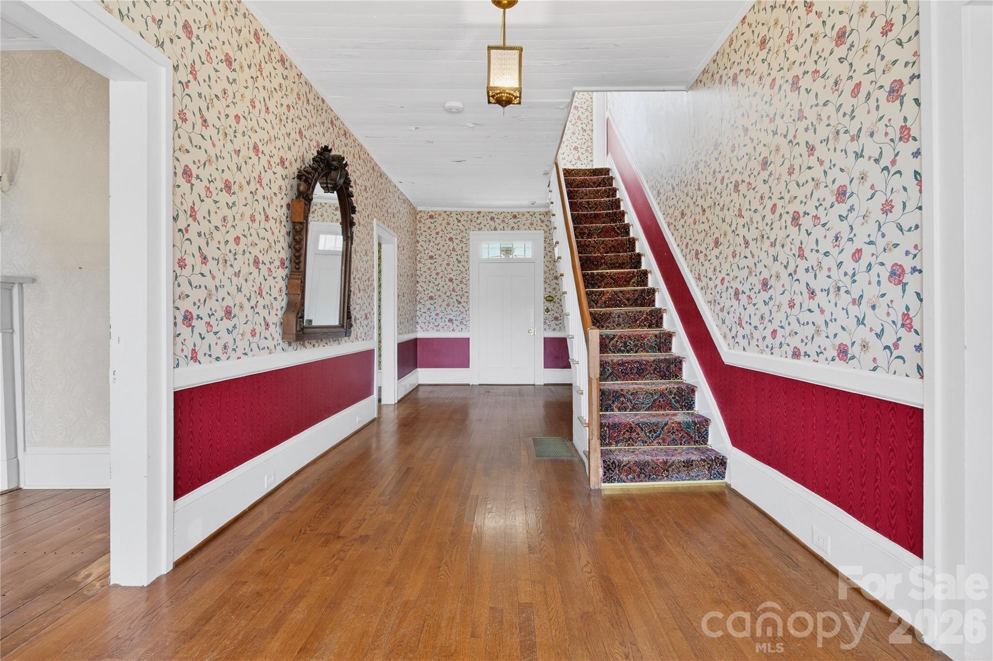Grand entry into the center hall with original millwork and a door to the sunroom at the rear porch - 11124 Eastfield Road, Huntersville