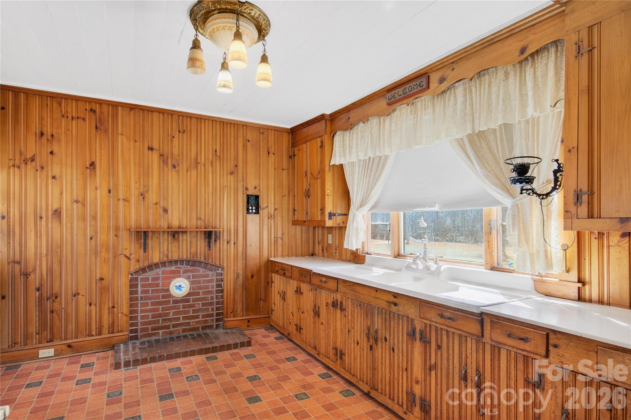 Kitchen has a masonry fireplace designed for a wood stove insert - 11124 Eastfield Road, Huntersville