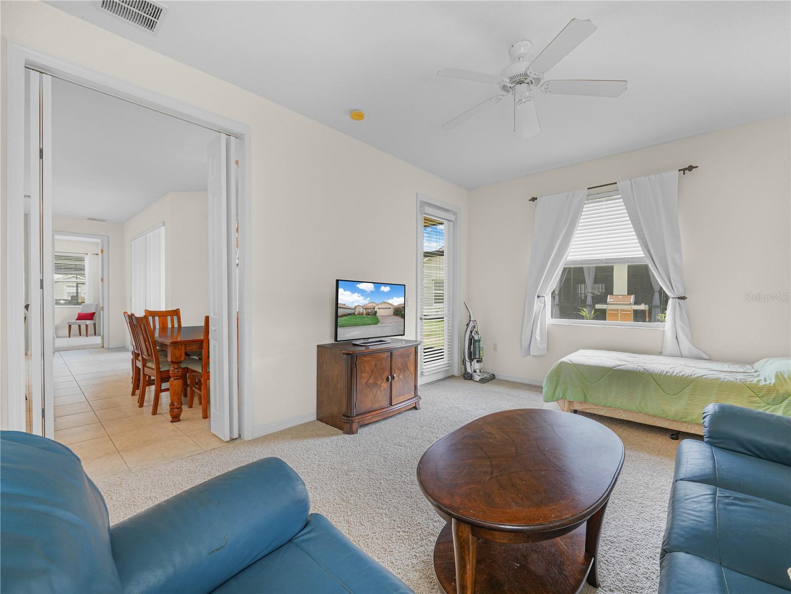 Bedroom 3  with Bi-Fold Doors and Door to Covered/Screened Lanai - 5264 GREEN DR, WINTER HAVEN