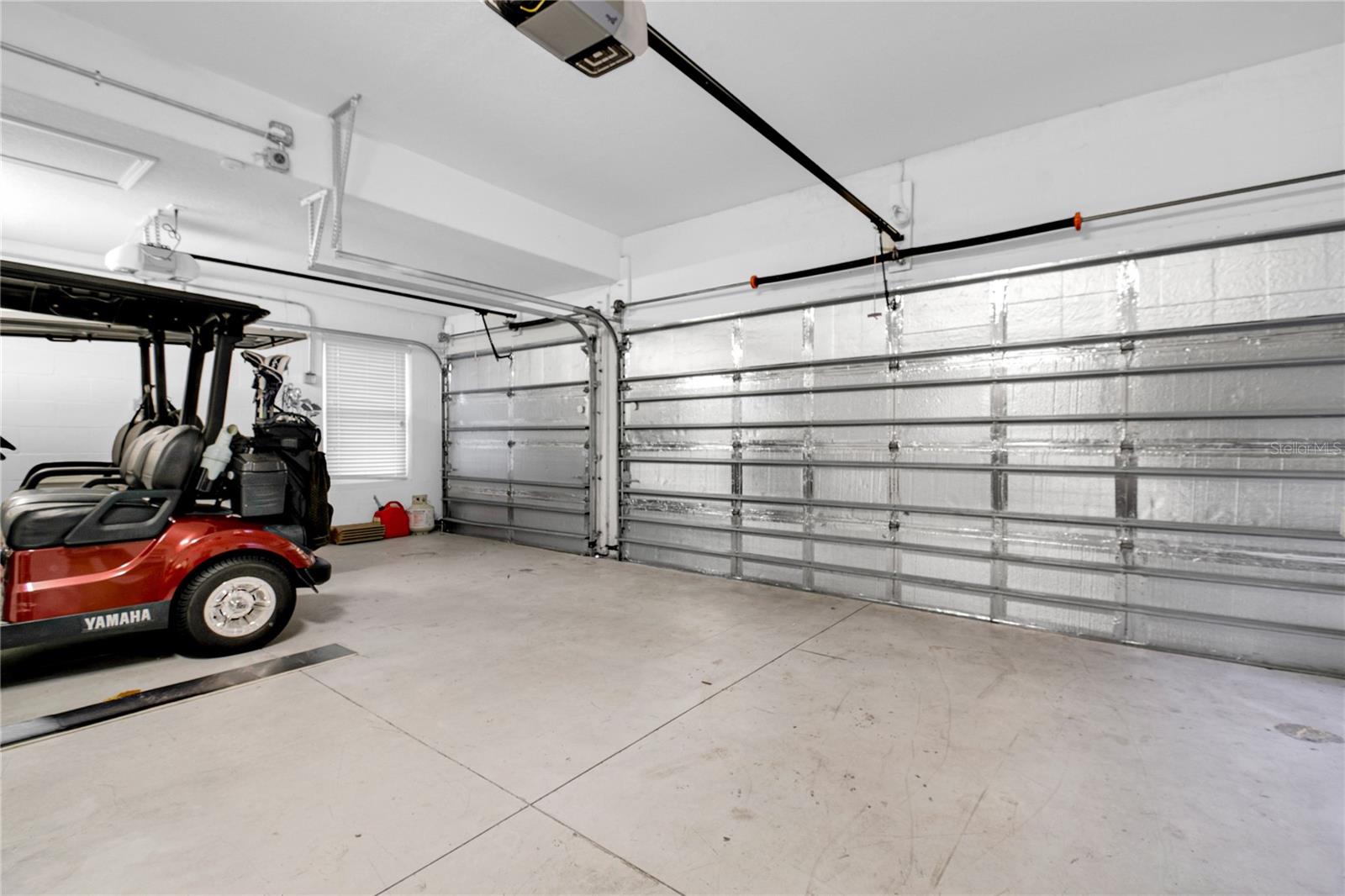 Climate Controlled 3 car garage with a mini-split A/C unit and insulation - 1301 GLENEAGLES LN, DAVENPORT