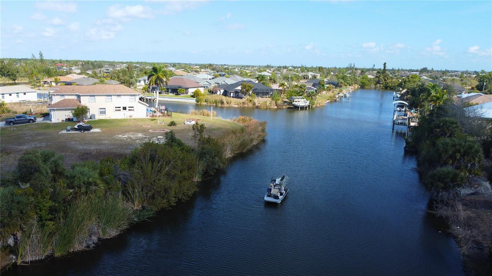 Aerial view of residential area featuring a large body of water - 9548 ATTICA CIR, PORT CHARLOTTE