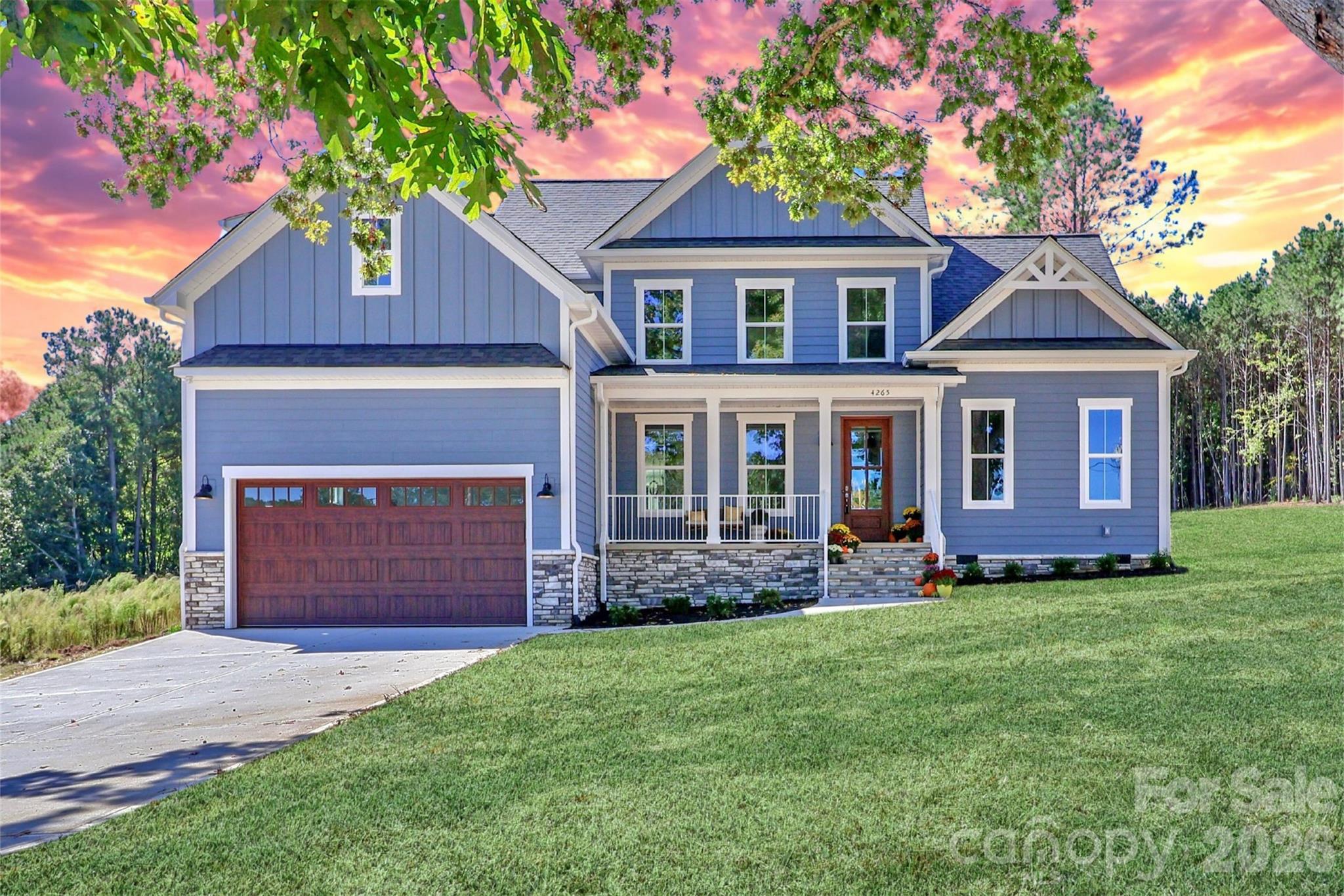 Beautifully crafted, new construction home featuring lake views, high-end finishes, an open-concept living space, and outdoor entertaining areas. - 4265 Candlewood Drive, Sherrills Ford