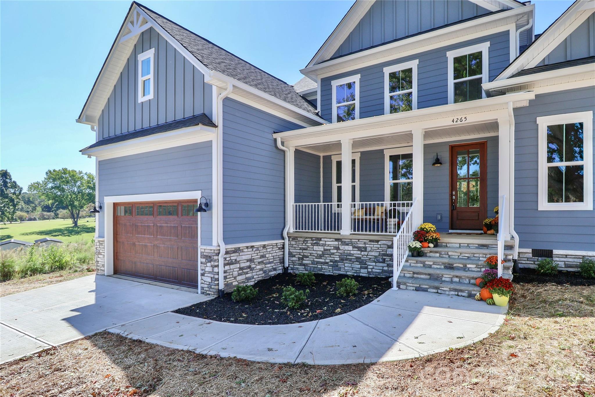 The spacious driveway, attached garage, and front walkway all add character and elegance to this custom-built home. The design elements work together to create curb appeal. - 4265 Candlewood Drive, Sherrills Ford
