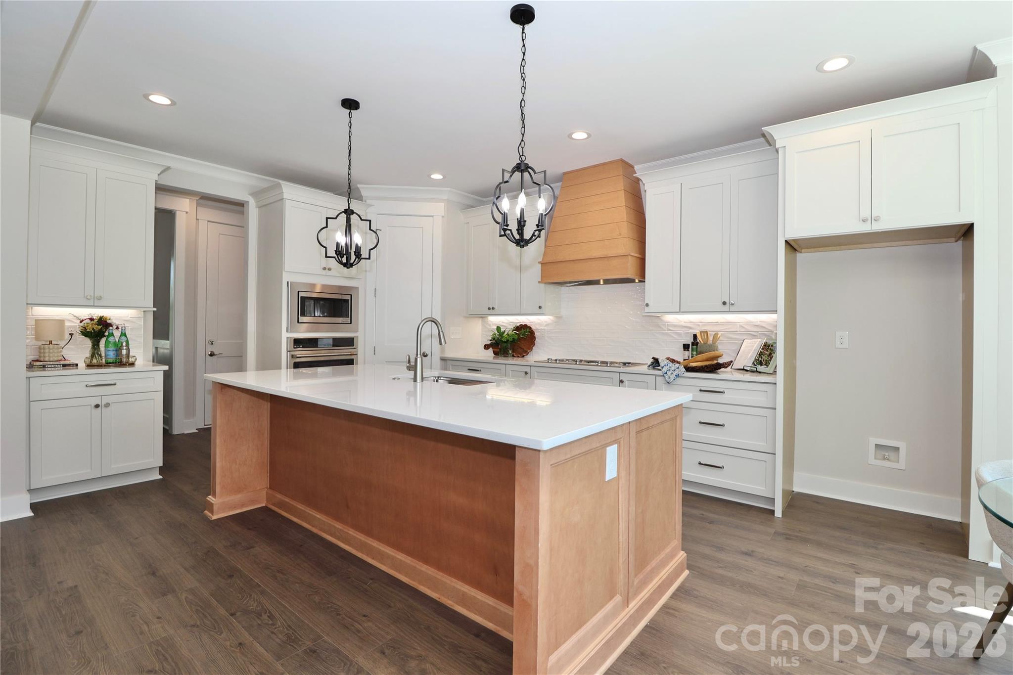 A gorgeous chef-inspired kitchen with Quartz countertops featuring a large center island. Ideal for gatherings and entertainment. - 4265 Candlewood Drive, Sherrills Ford