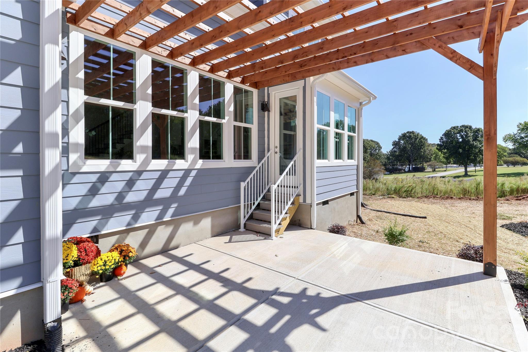 Enjoy the custom-built pergola, which serves as a peaceful outdoor space, enhancing both the aesthetic appeal and entertainment options for your home. - 4265 Candlewood Drive, Sherrills Ford