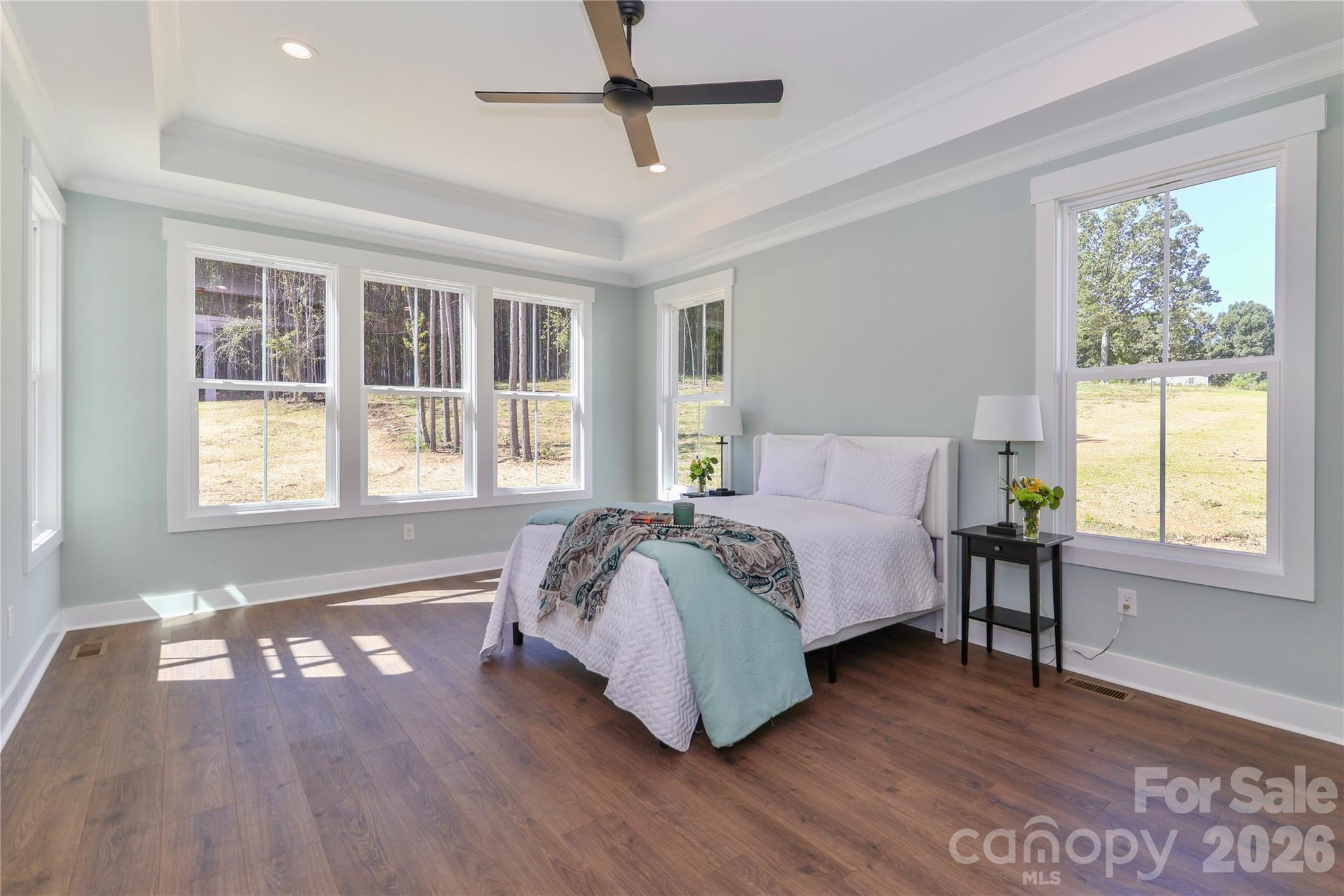 Drenched in natural light, the primary bedroom is spacious, peaceful retreat, offering a tranquil escape. - 4265 Candlewood Drive, Sherrills Ford