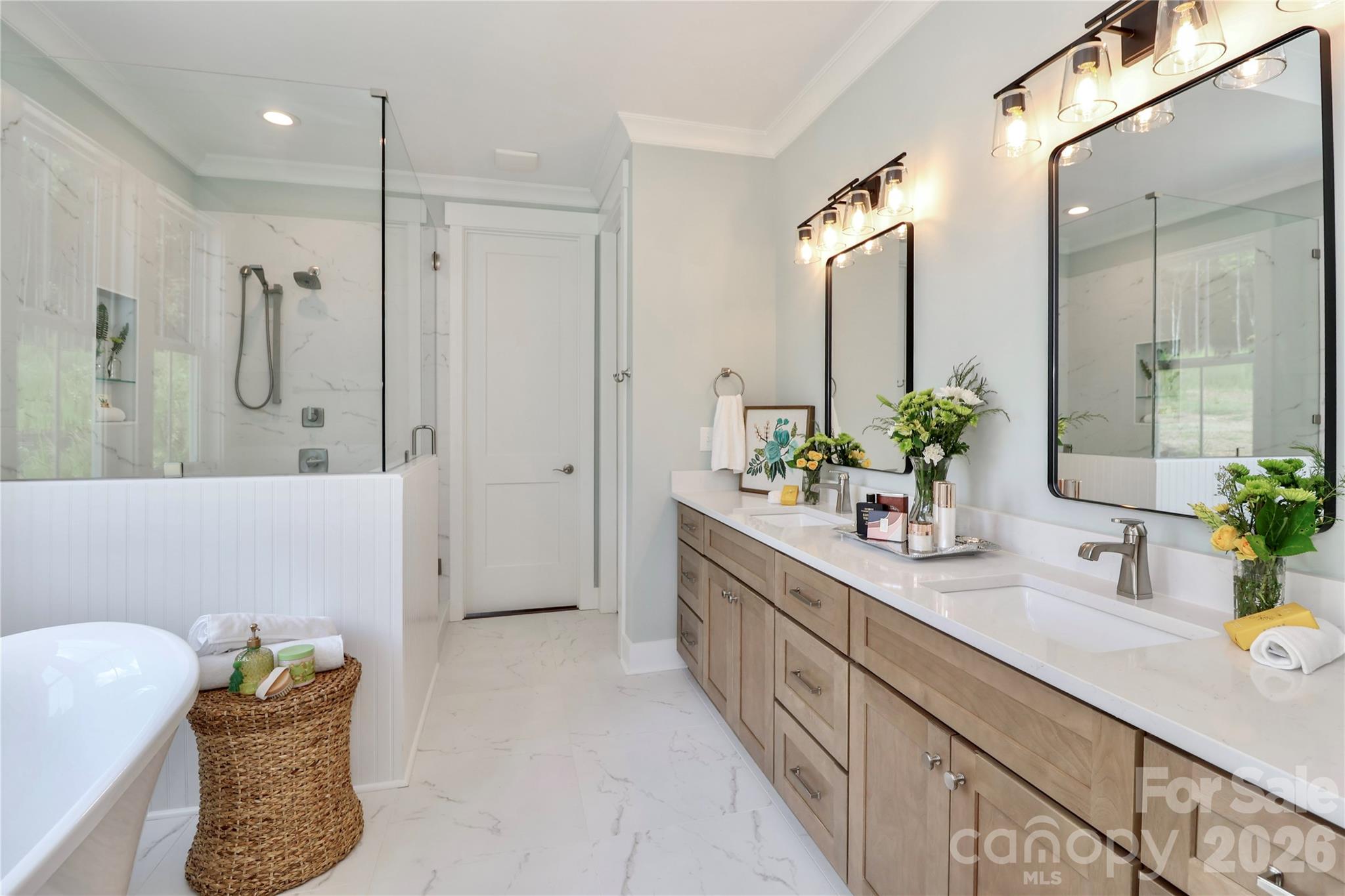 This bathroom offers a luxurious and relaxing experience. The design elements incorporate calming colors, natural materials, while highlighting features including a soaking tub, a rain shower, and shower seating. - 4265 Candlewood Drive, Sherrills Ford