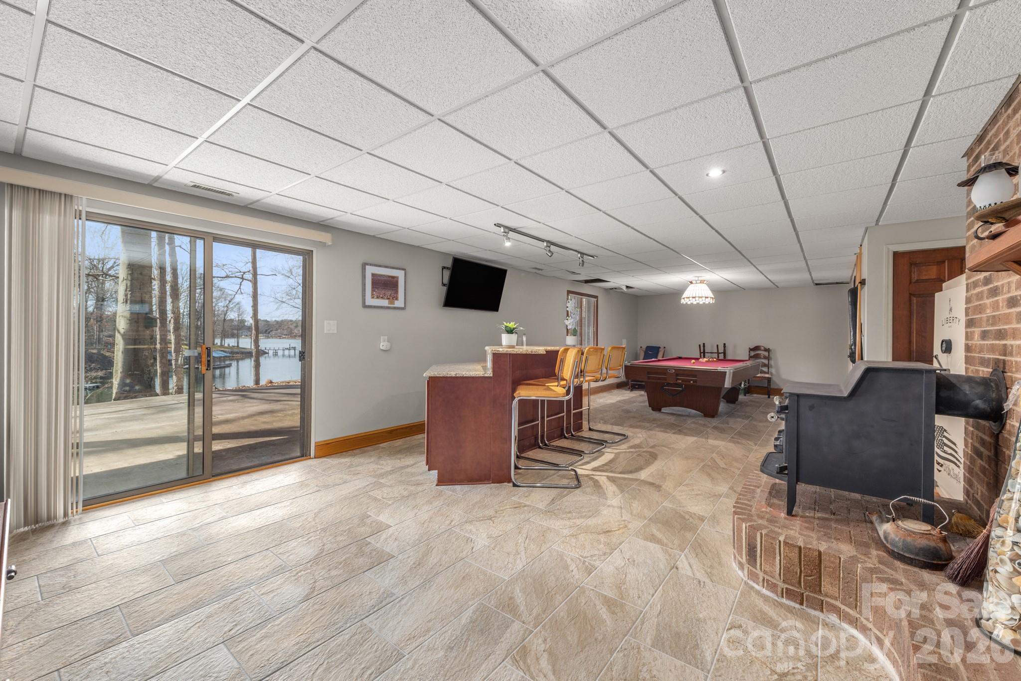 Large open recreation area with access to the patio and lake - 151 Bridlewood Drive, Mooresville