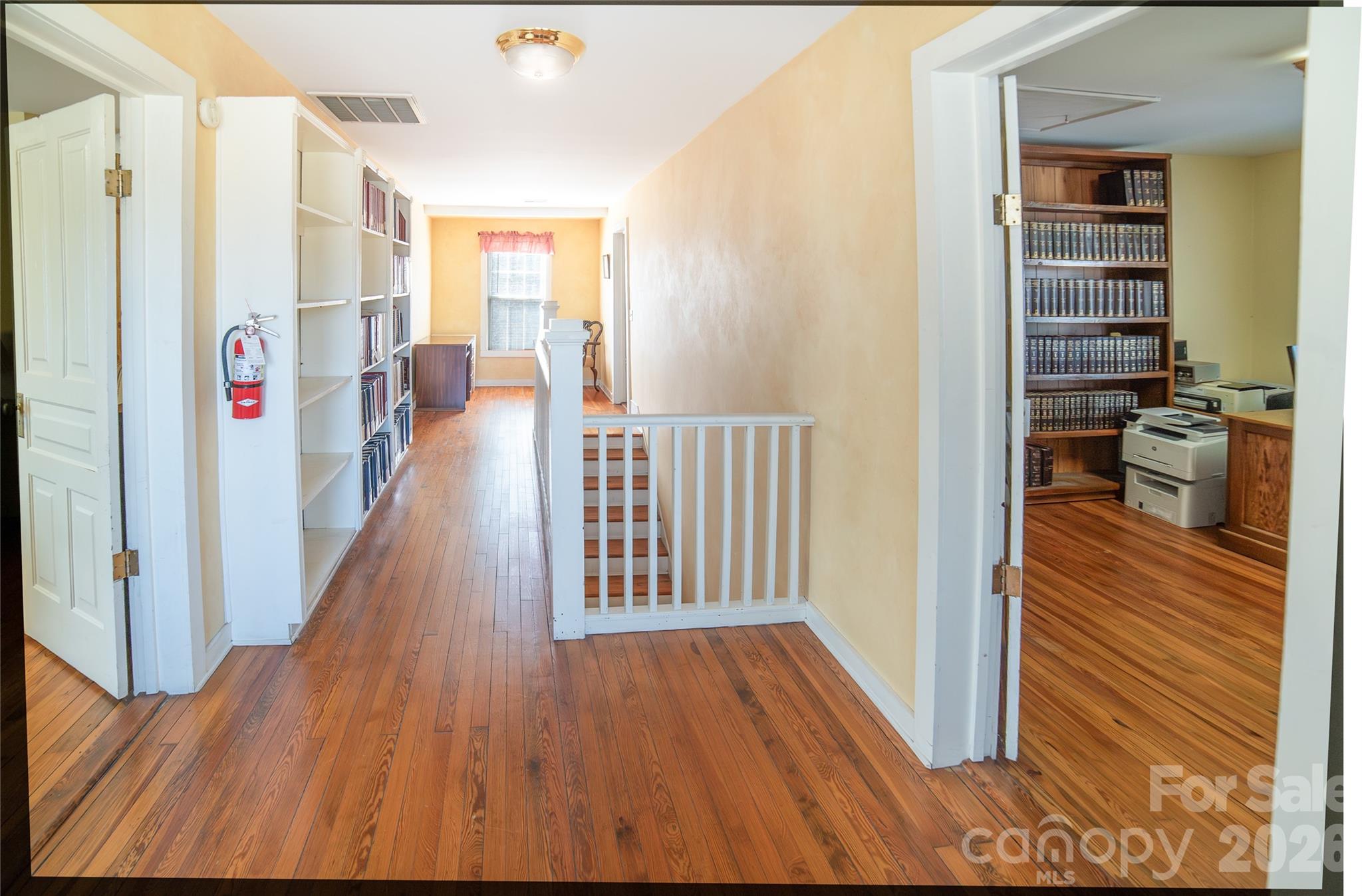 Upstairs hallway, extensive bookshelves. - 508 Mulberry Street SW, Lenoir