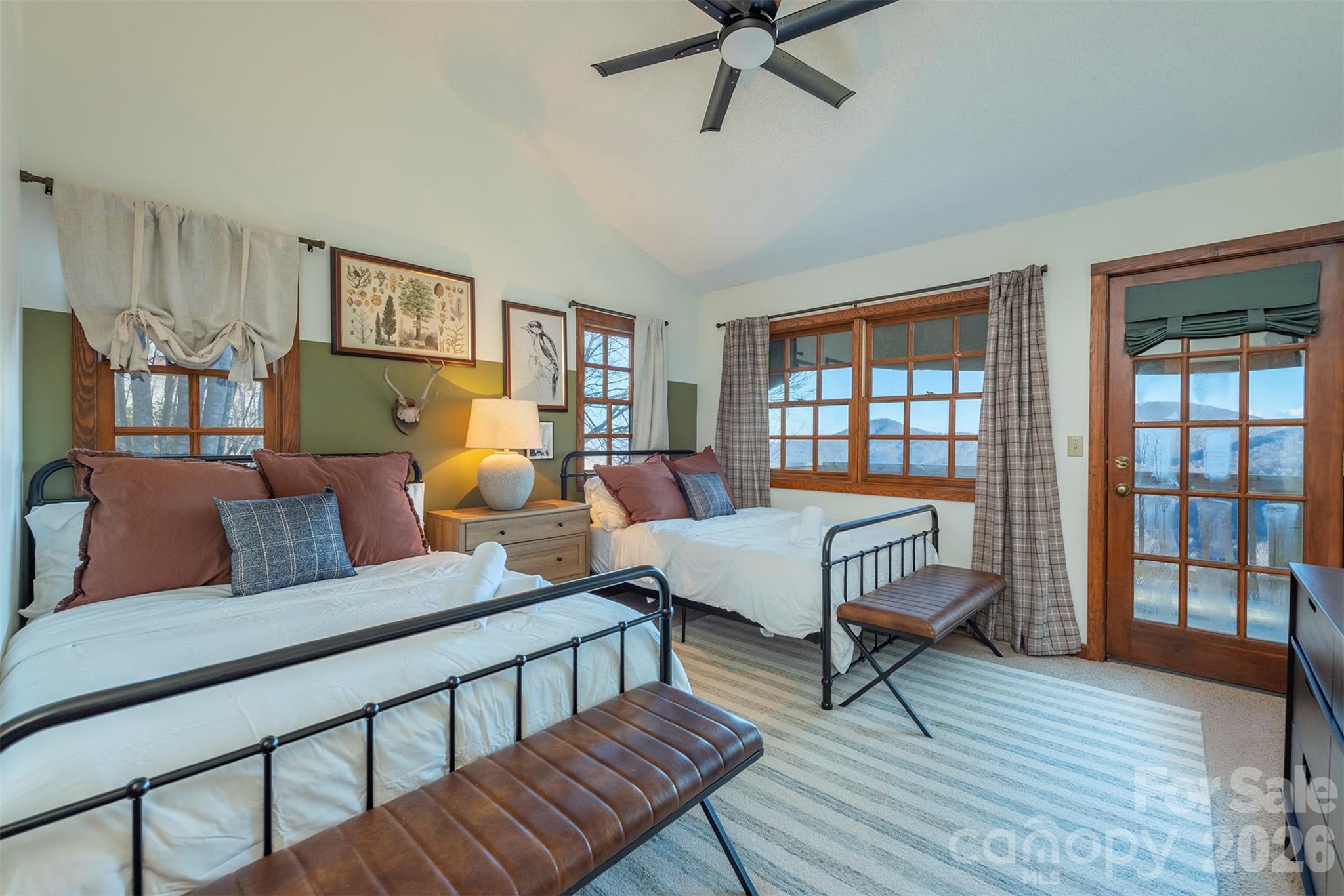 BR#2 Main floor guest bedroom. Double the beds, double the comfort. No need to flip a coin—everyone gets their own cozy spot to crash after a day of adventures. - 322 Goldenleaf Road, Mars Hill