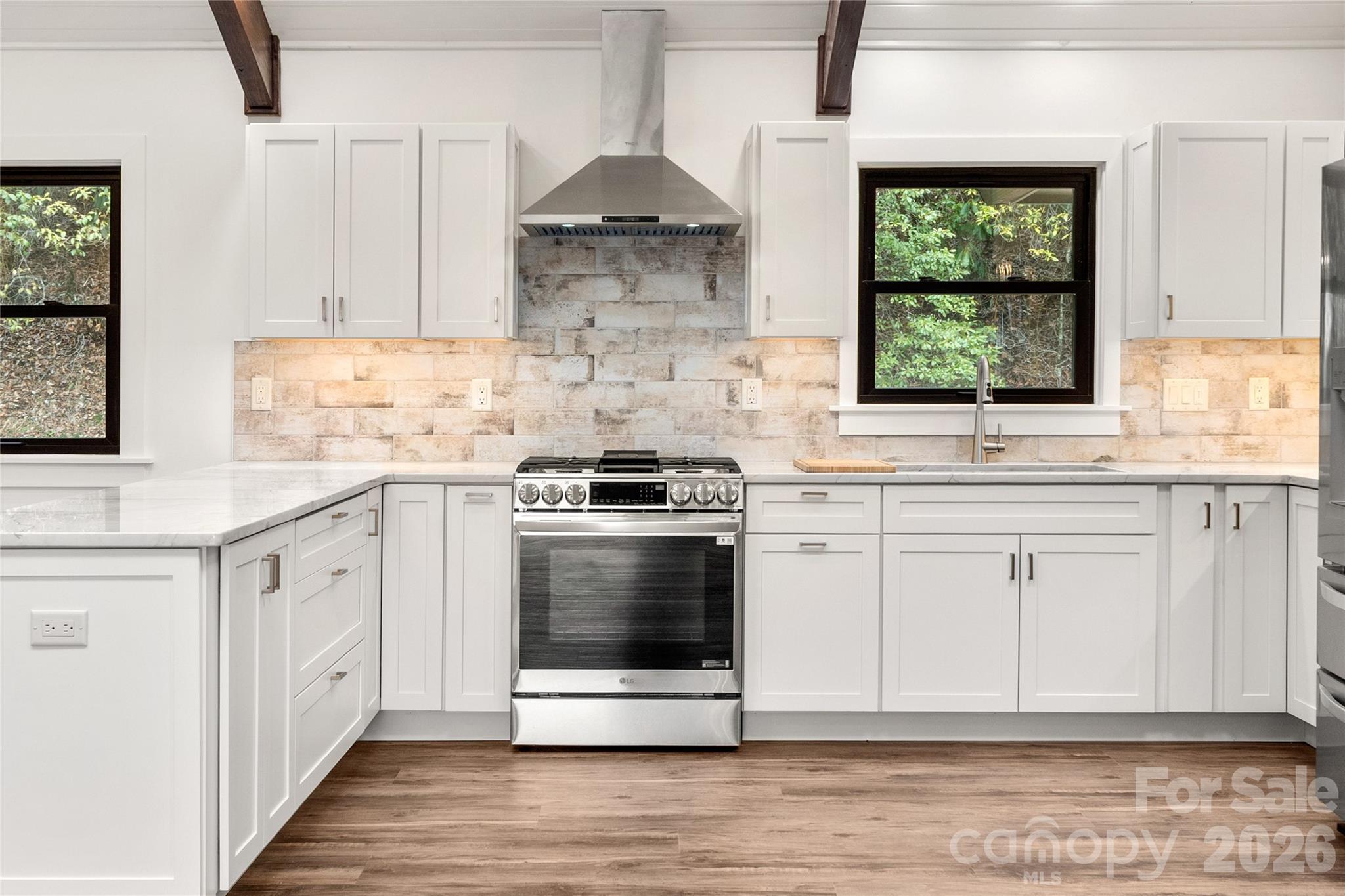 Custom cabinets provide both style and abundant storage. - 453 Friendly Acres Drive, Waynesville
