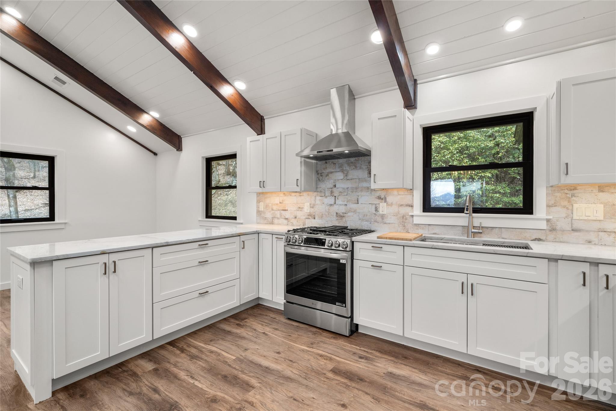 Completely renovated kitchen with custom cabinetry and new appliances. - 453 Friendly Acres Drive, Waynesville