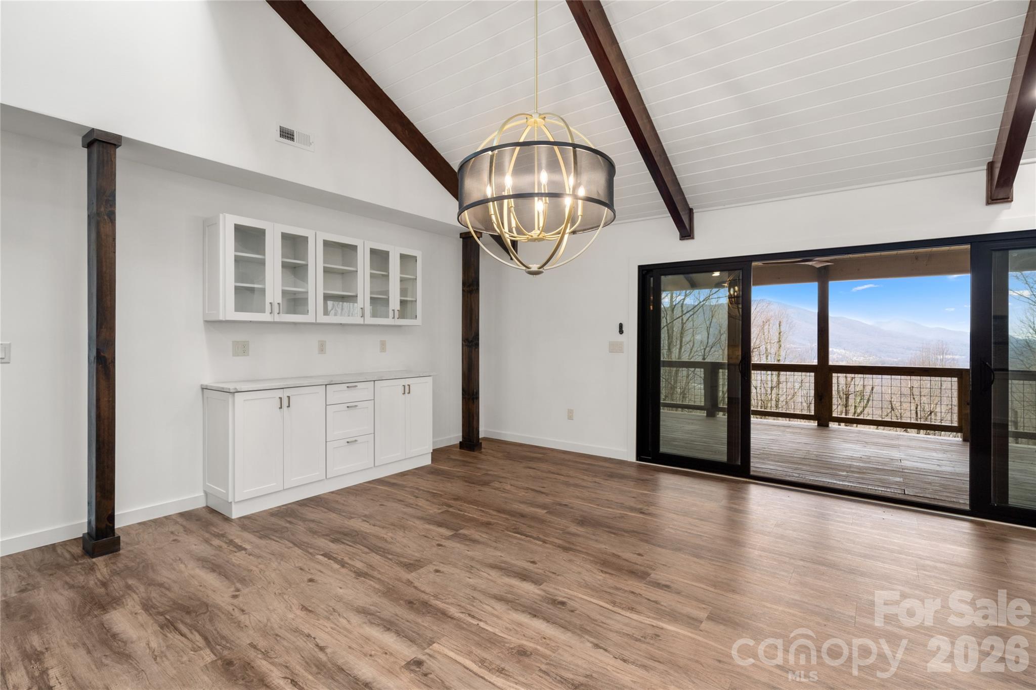 Open dining and living with built in custom cabinets - 453 Friendly Acres Drive, Waynesville