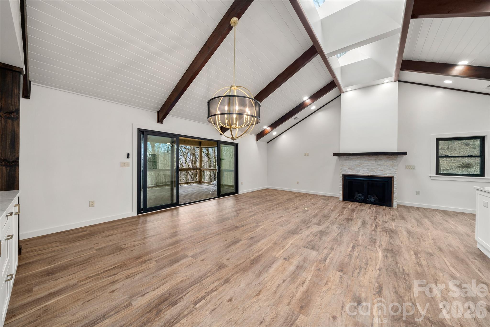 Sliding glass doors to deck, beamed cathedral ceilings - 453 Friendly Acres Drive, Waynesville
