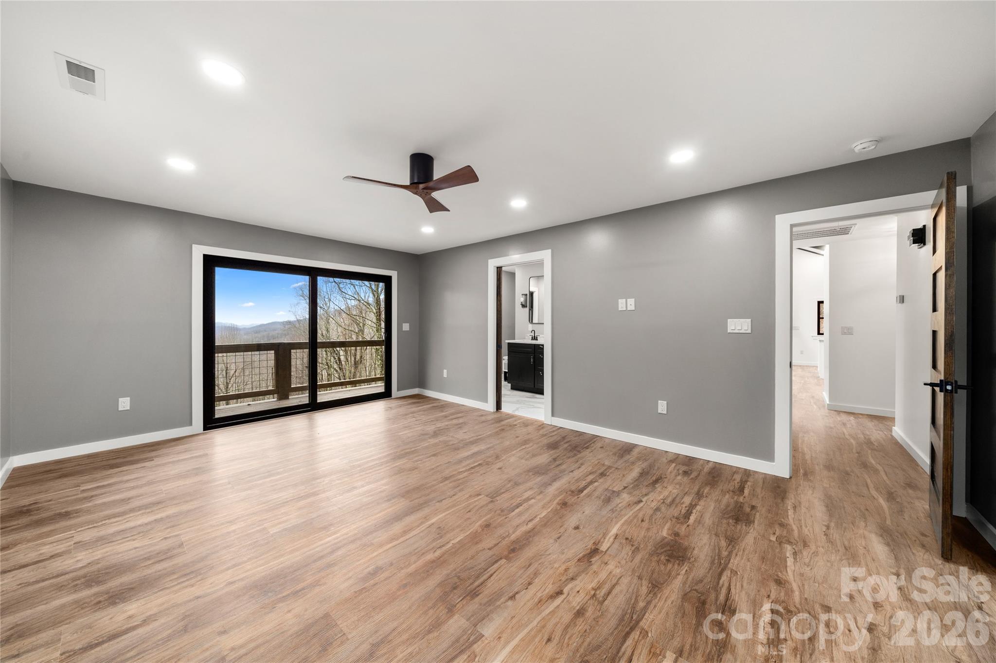 Spacious main level primary suite with fresh paint and new flooring, new lighting - 453 Friendly Acres Drive, Waynesville