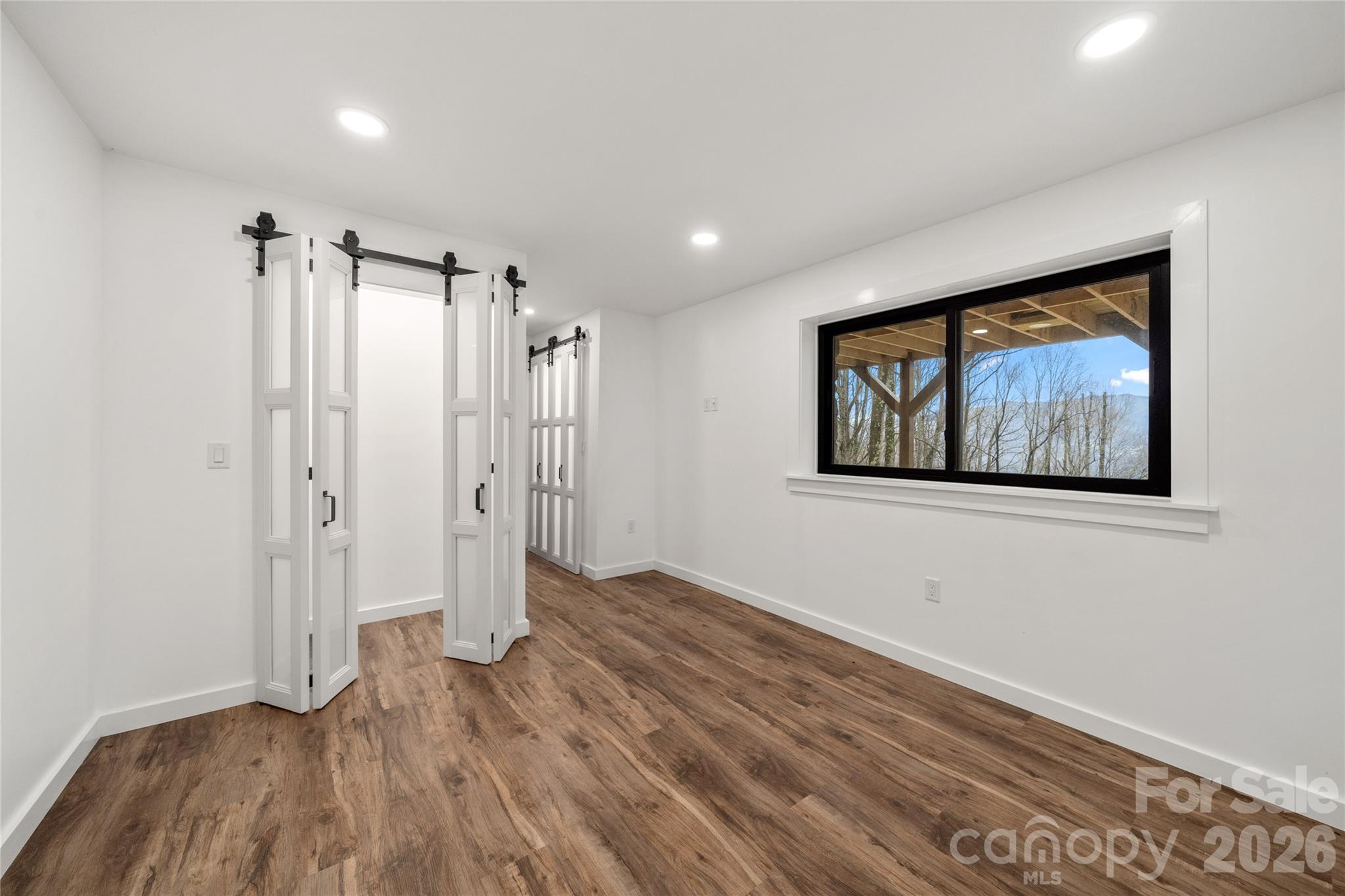 Downstairs/Basement 2nd Bedroom w/ new flooring, lighting, windows - 453 Friendly Acres Drive, Waynesville